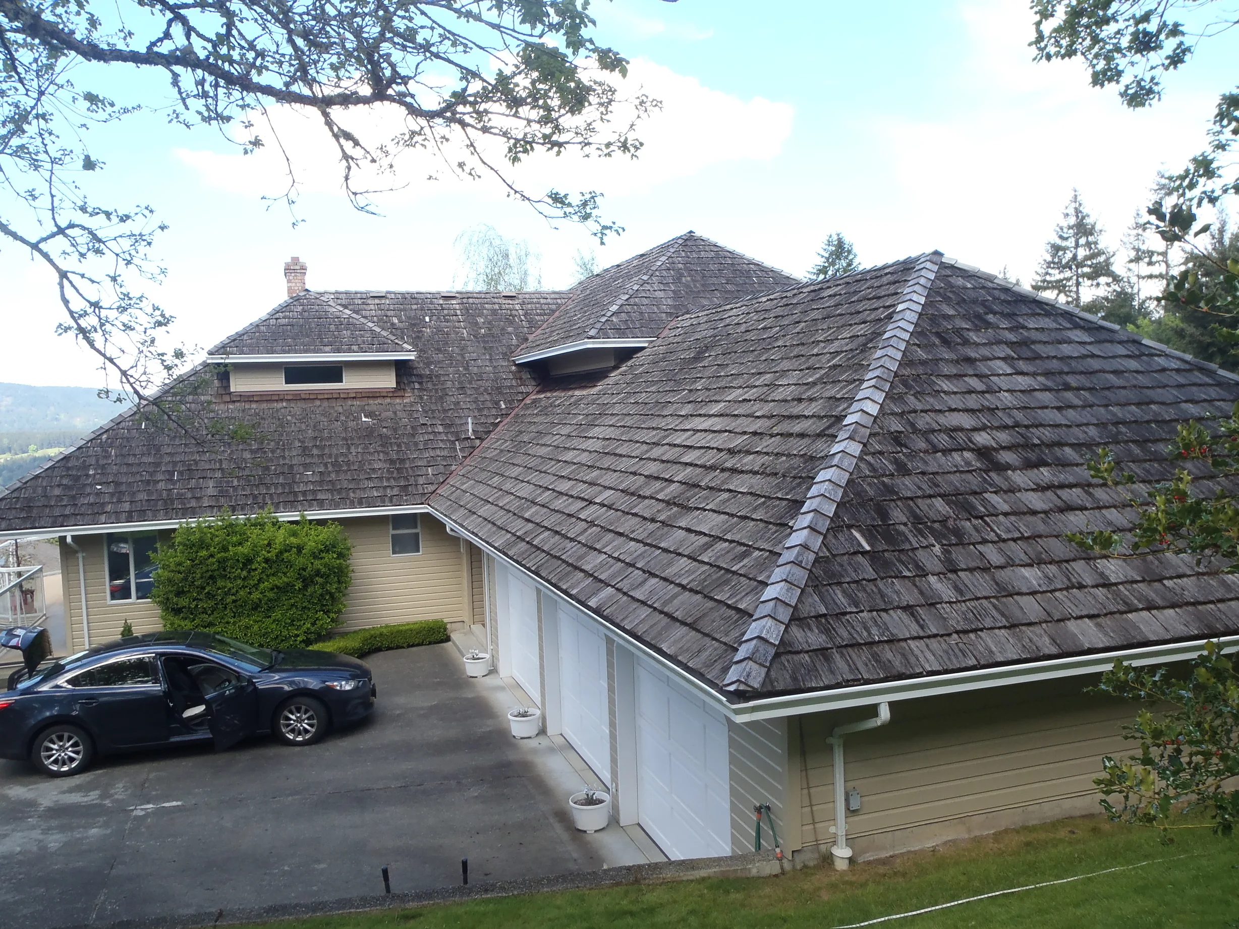 Before: a rotten wood shake roof on the home, Duncan, British Columbia, ahead of a Deep Charcoal Interlock Slate aluminum roof