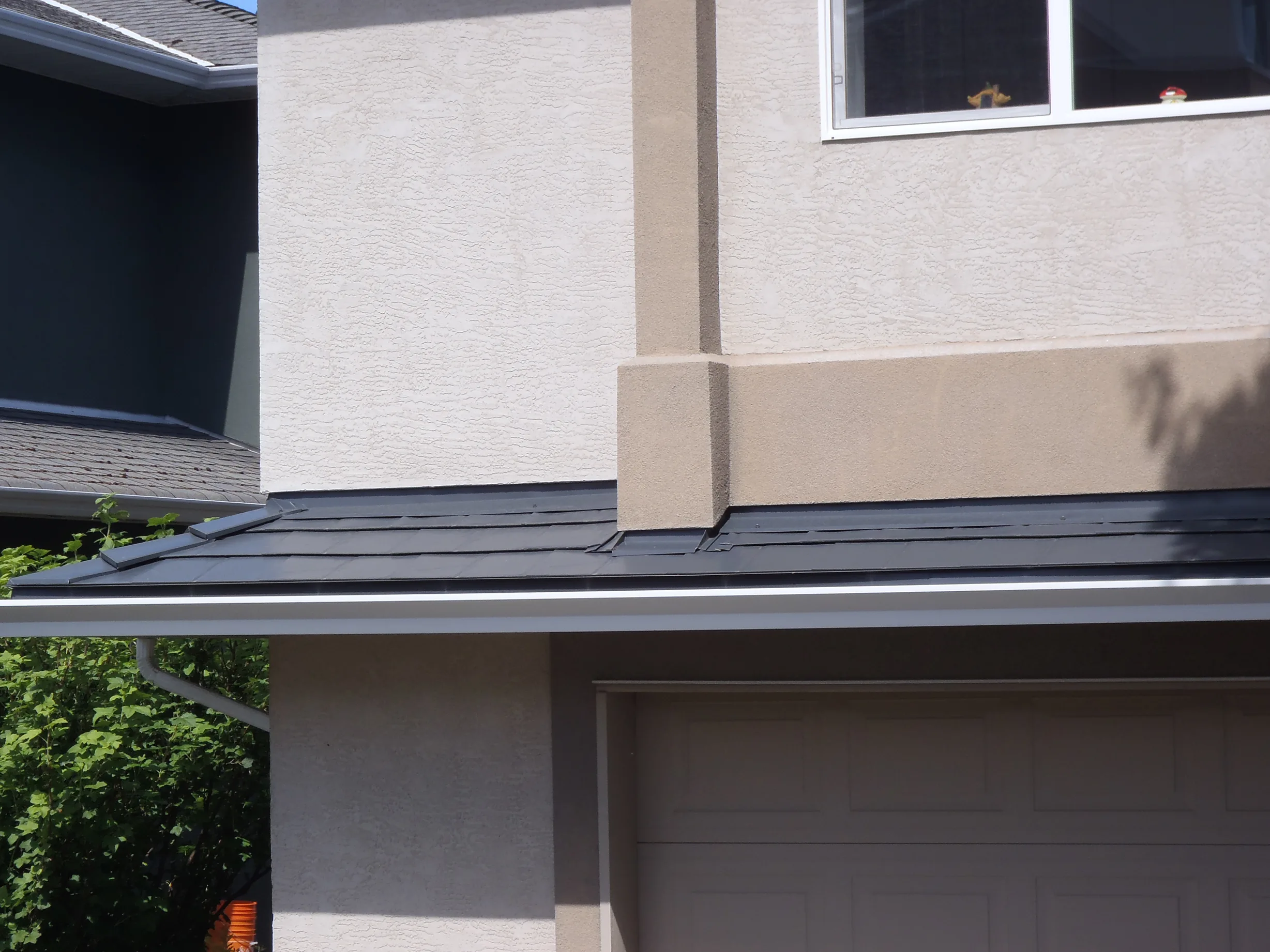 Deep Charcoal Interlock Slate aluminum roof on a modern home with a metal roof in progress in a suburban, Victoria, British Columbia