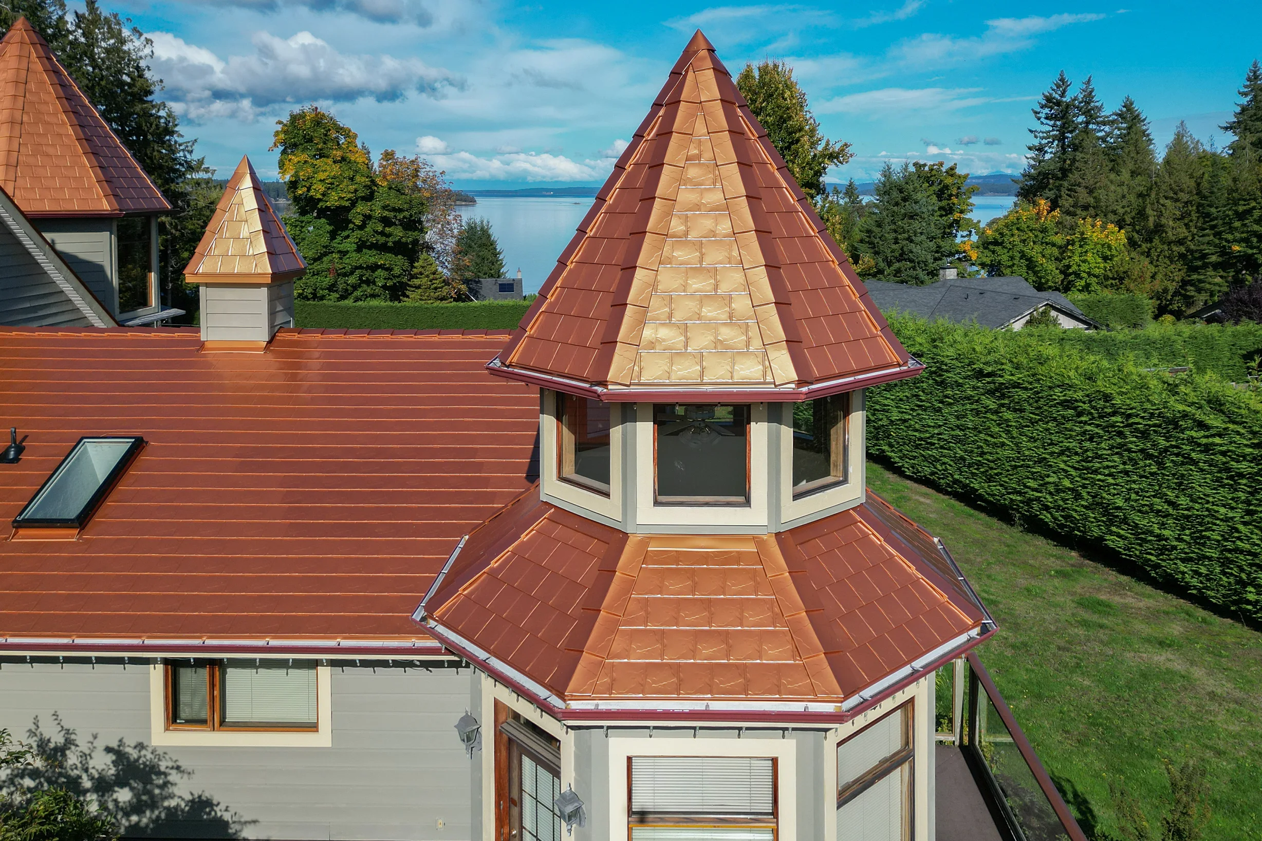 Copper Penny Interlock Slate aluminum roof on a house with a copper penny metal roof on a coastal property, Ladysmith, British Columbia
