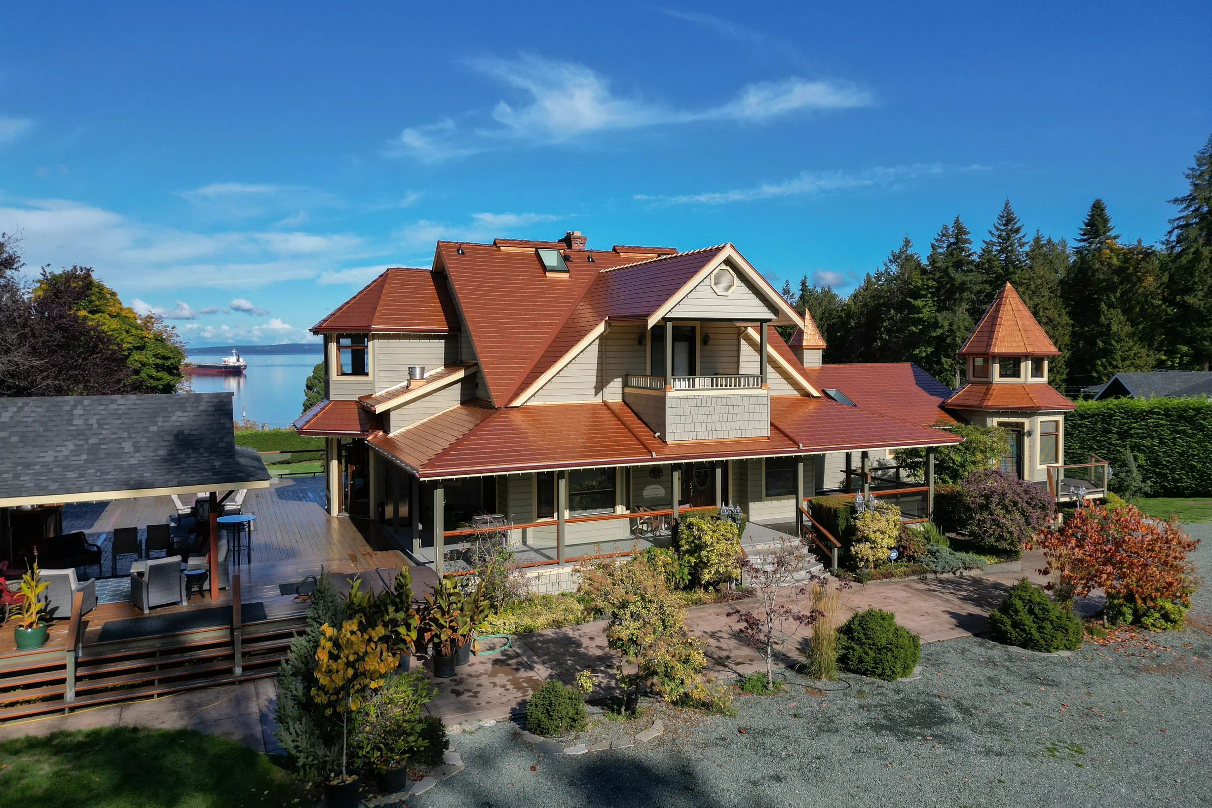 Copper Penny Interlock Slate aluminum roof on a grey home with copper roof and dormers on the waterfront, Ladysmith, British Columbia