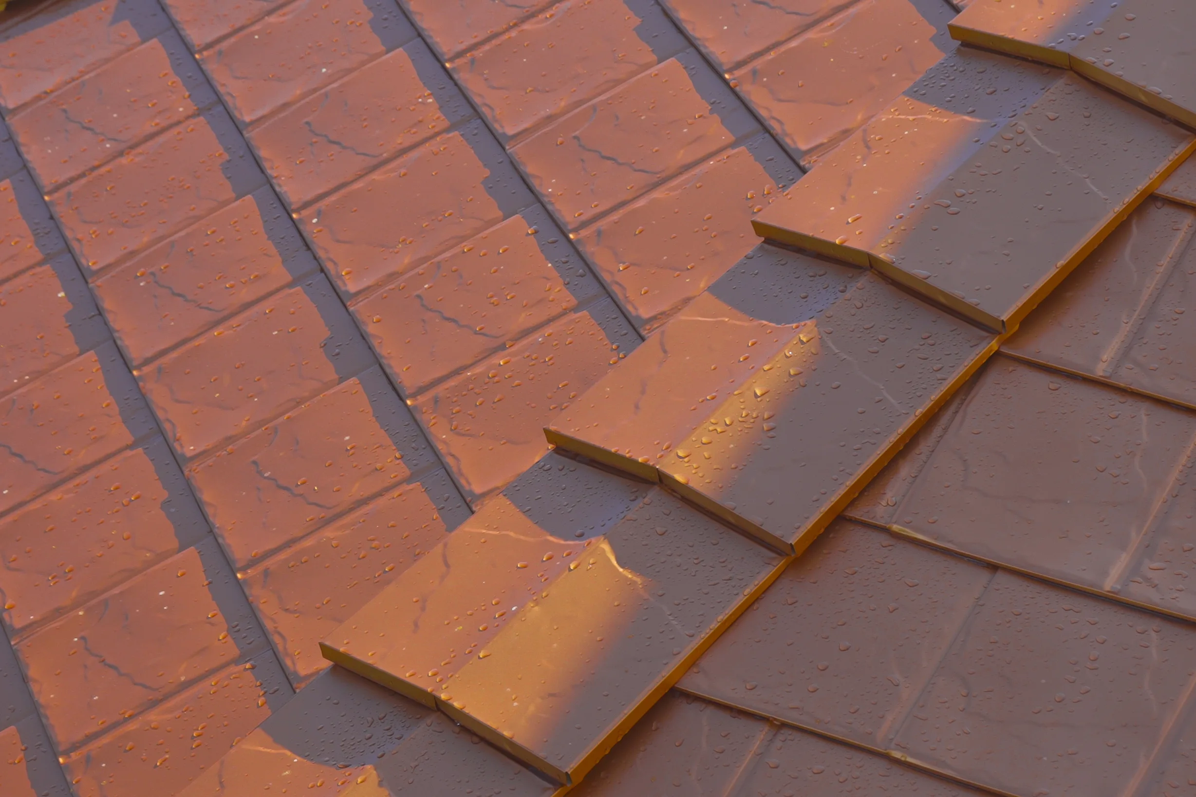 Copper Penny Interlock Slate aluminum roof on a brown house with a metal roof among tall trees, Ladysmith, British Columbia