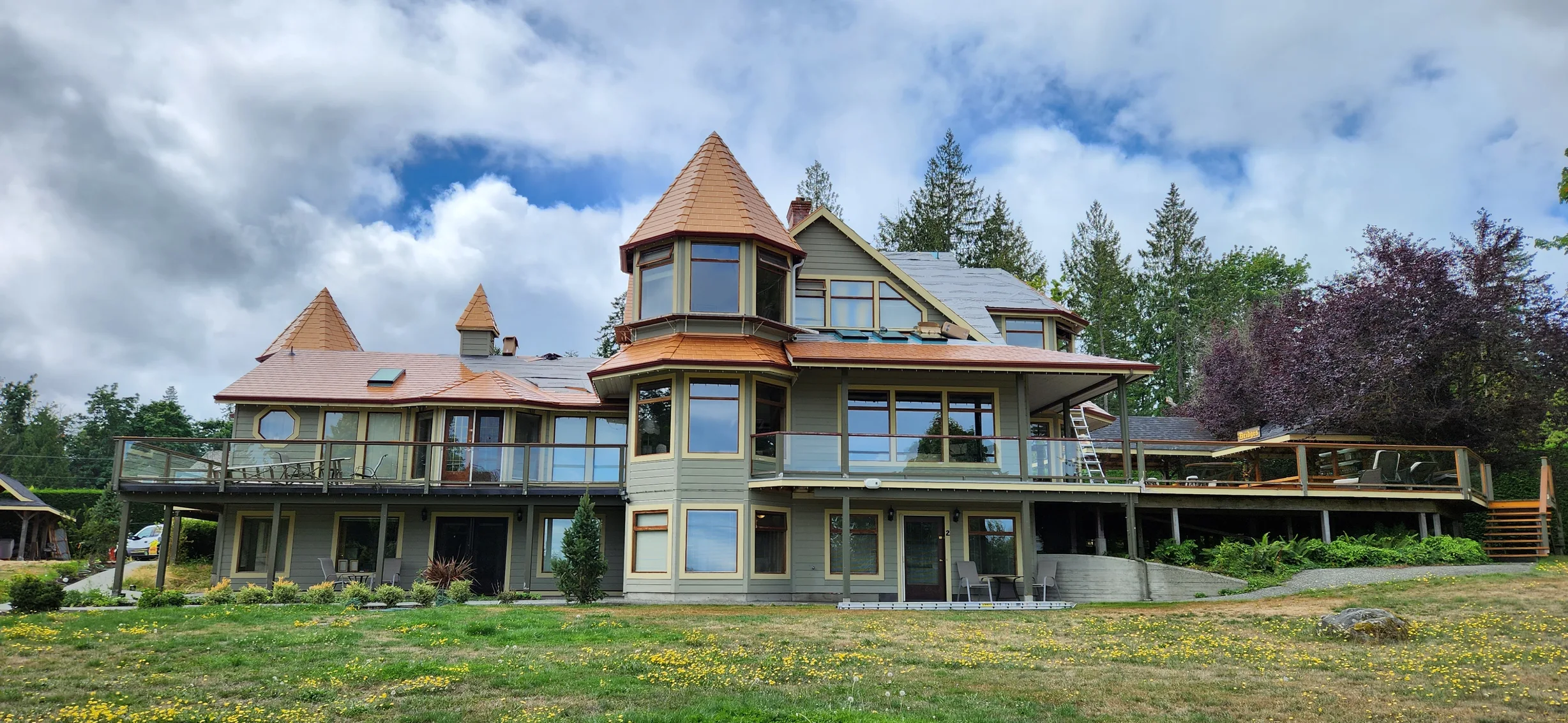 Copper Penny Interlock Slate aluminum roof being installed on the home, replacing a worn out wood shake roof, Ladysmith, British Columbia