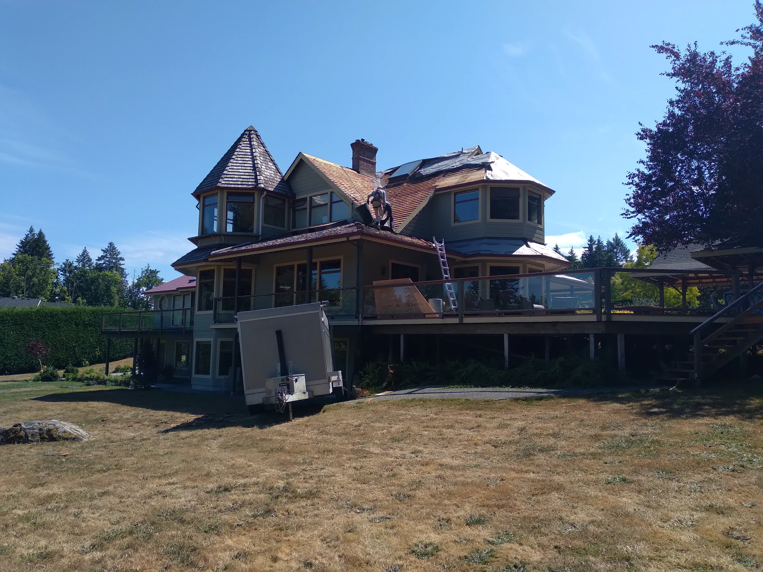 Copper Penny Interlock Slate aluminum roof being installed on the home, replacing a worn out wood shake roof, Ladysmith, British Columbia