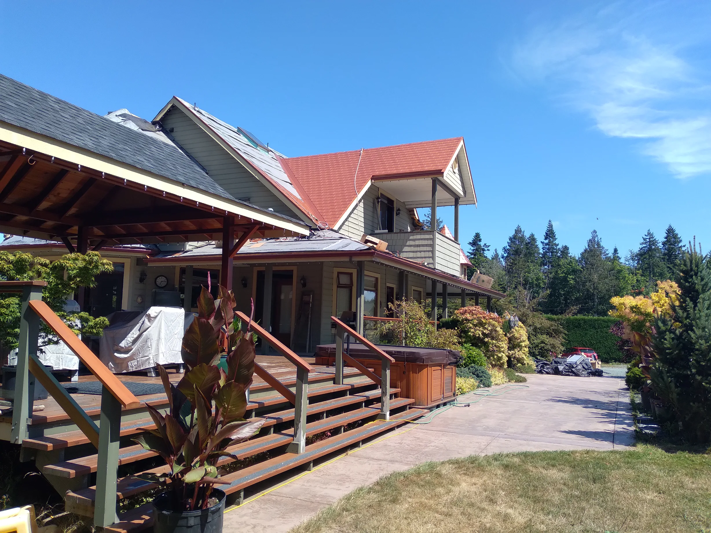 Copper Penny Interlock Slate aluminum roof being installed on the home, replacing a worn out wood shake roof, Ladysmith, British Columbia