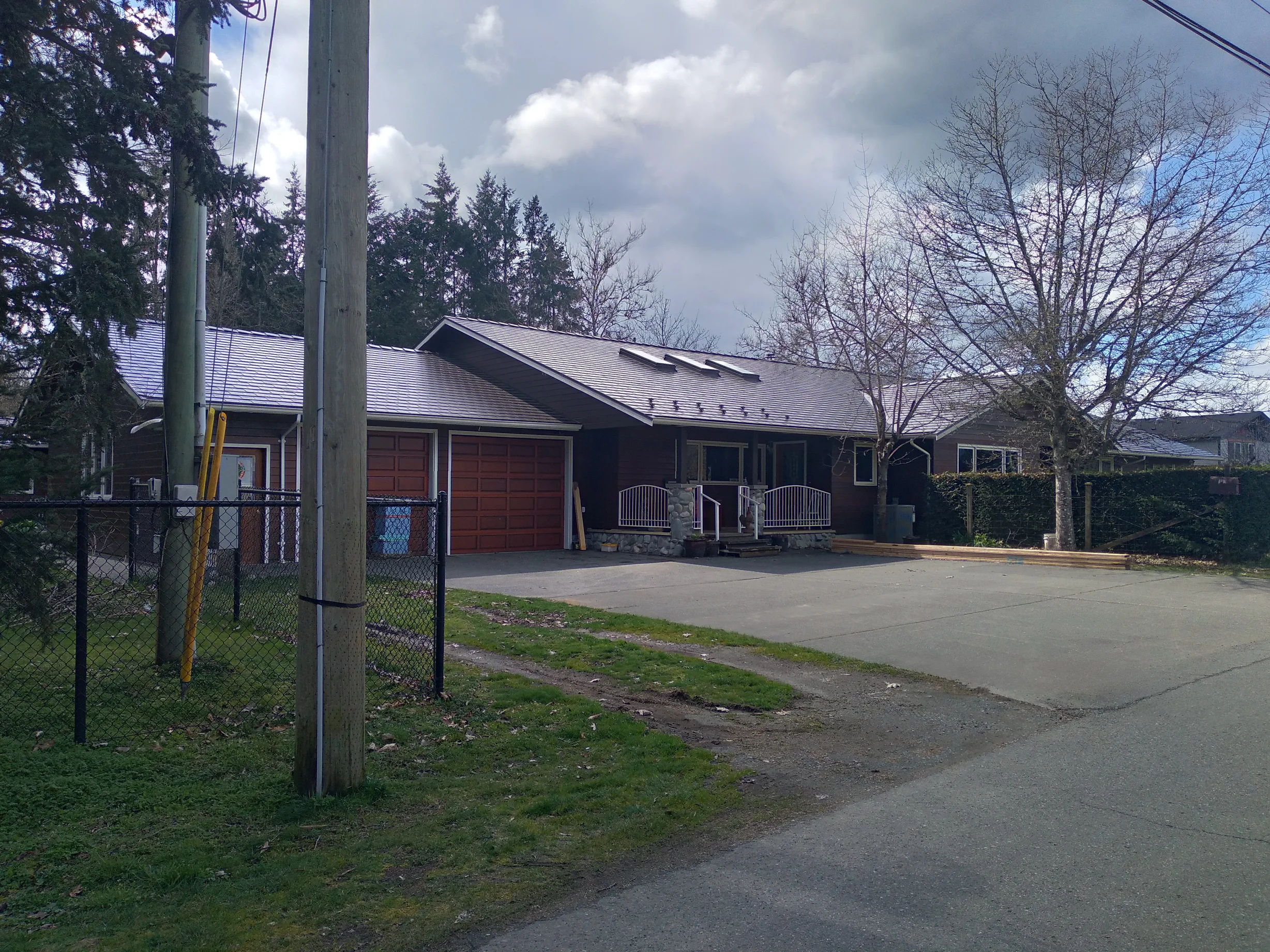 Tudor Brown Interlock Slate aluminum roof on a brown home with a metal roof in a rural setting, Duncan, British Columbia