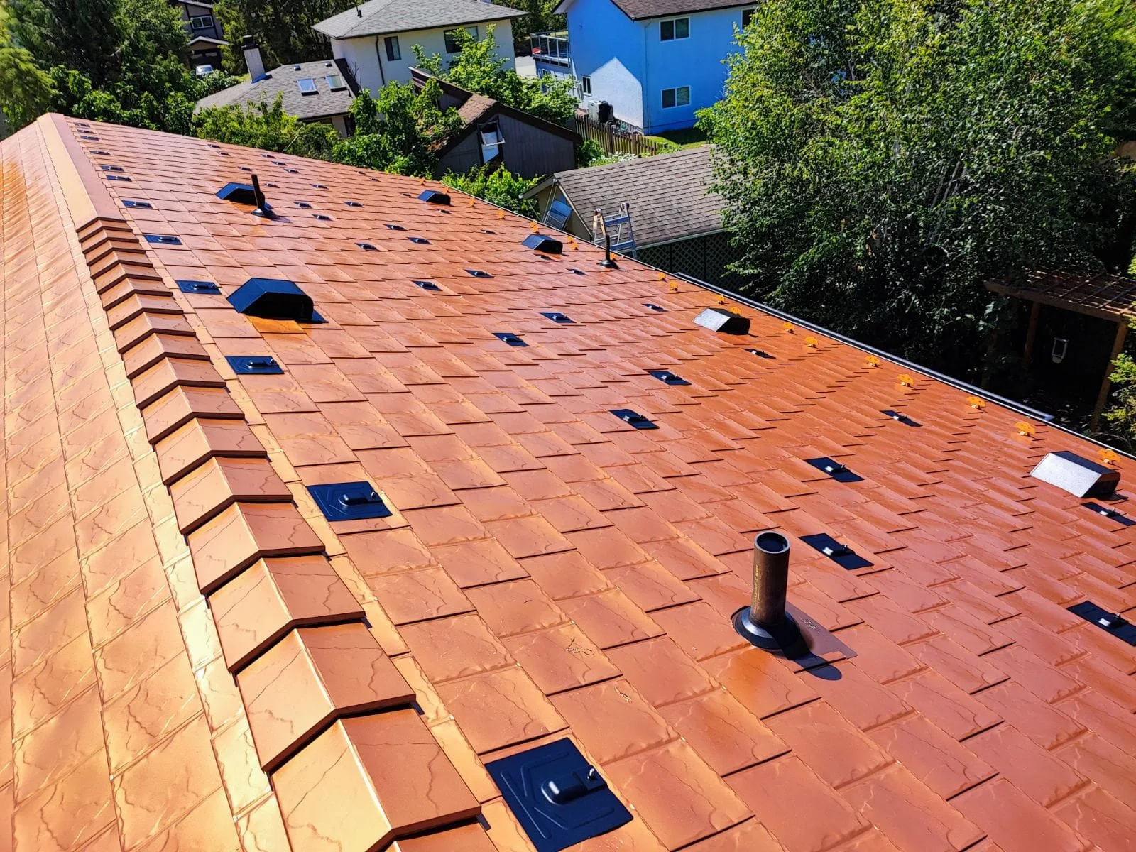 Copper Penny Interlock Slate aluminum roof on a brown single-family home with a copper penny metal roof, Victoria, British Columbia