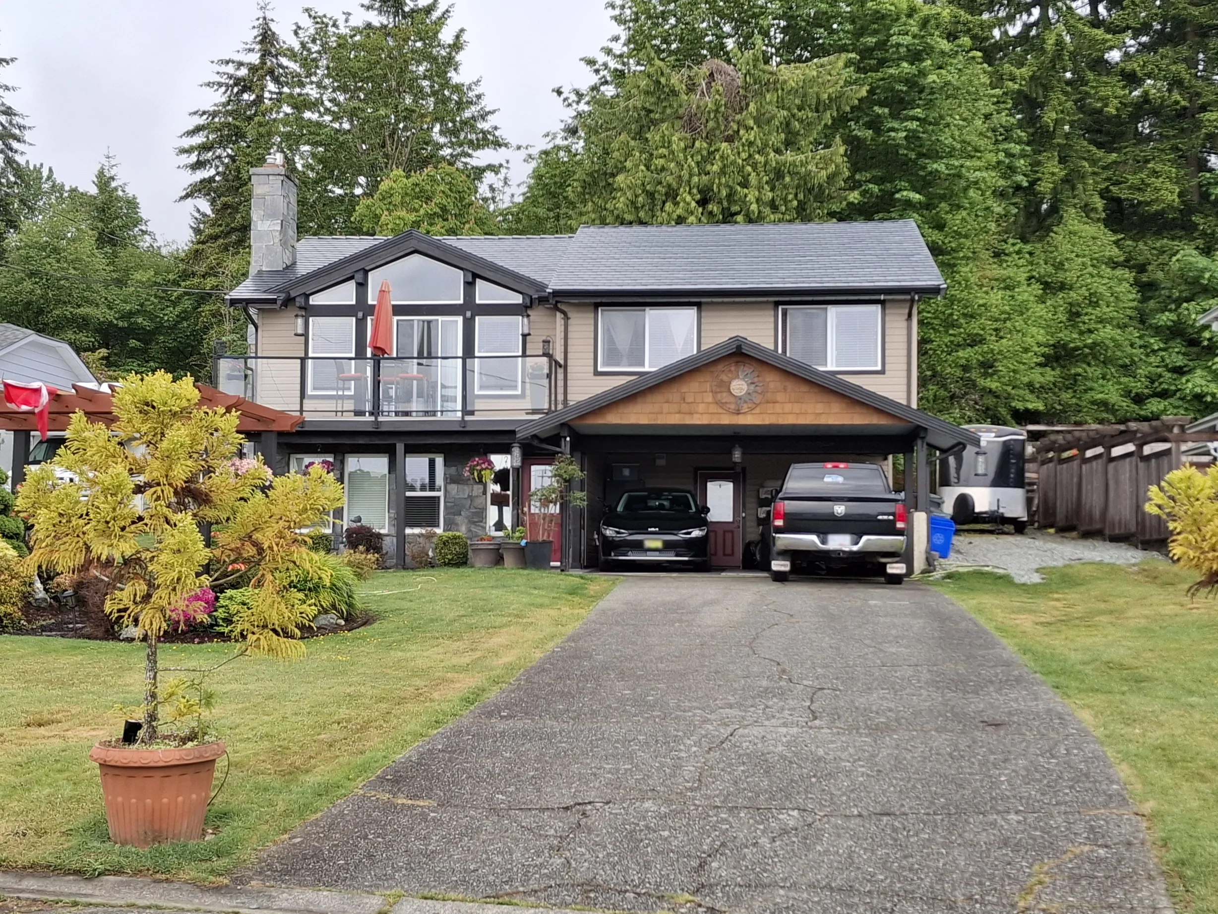 Black Interlock Slate aluminum roof on a black two-storey home with a metal roof and a garage, Chemainus, British Columbia