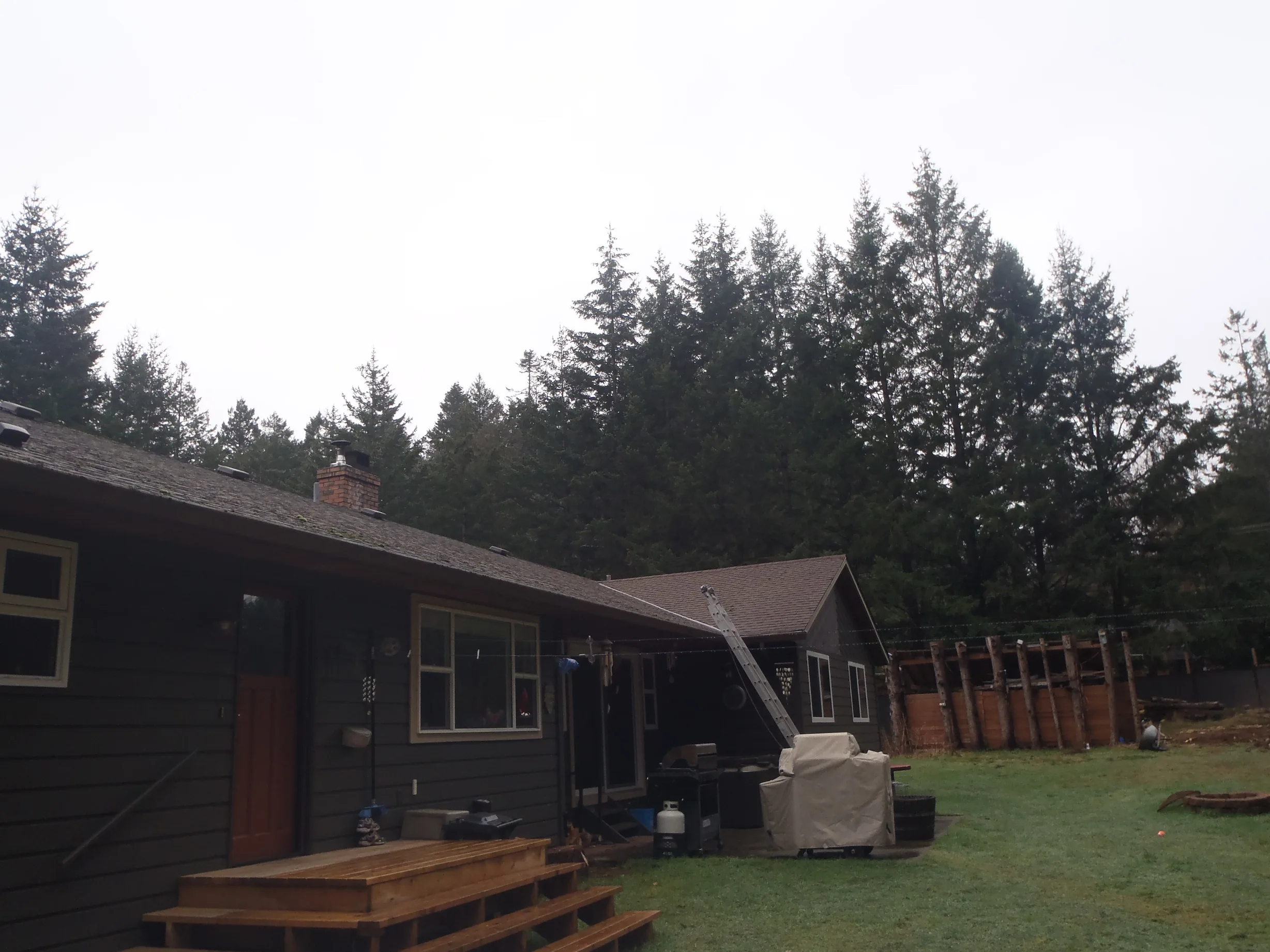 Before: a leaking asphalt shingle roof on the home, Comox, British Columbia, ahead of a Black Interlock Slate aluminum roof