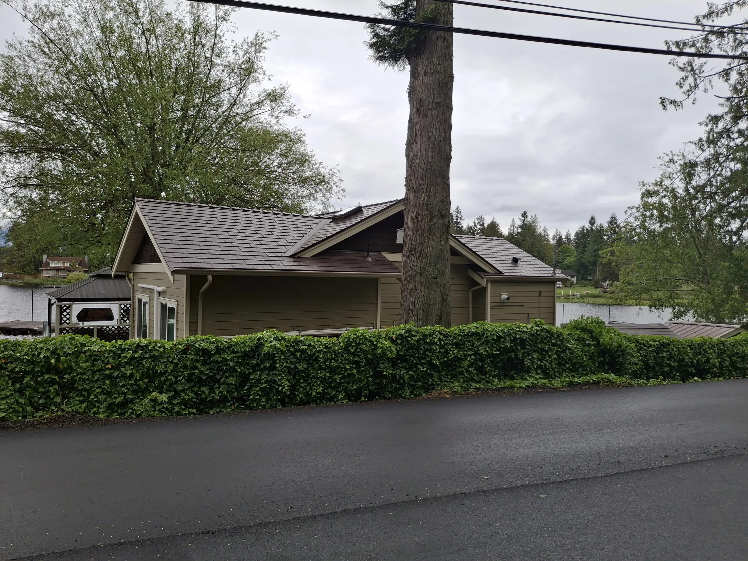 Colonial Brown Interlock Slate aluminum roof on a Colonial brown metal roof on a single-family home in a, Shawnigan Lake, British Columbia