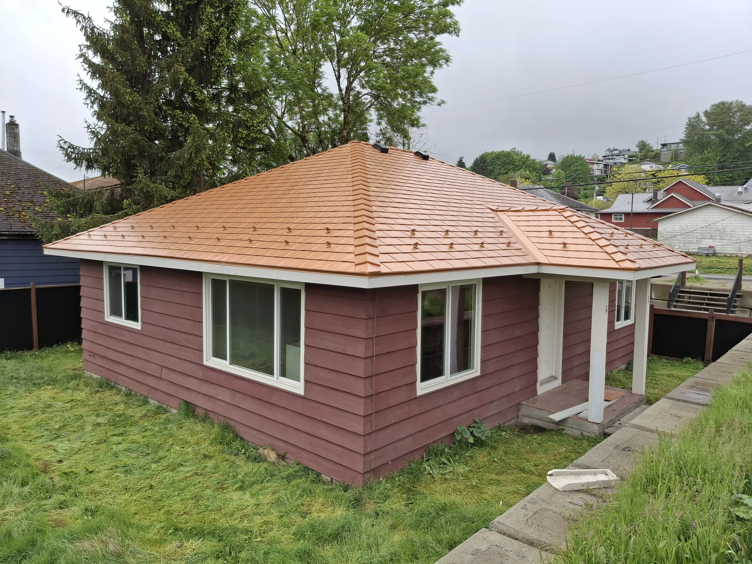 Copper Penny Interlock Slate aluminum roof on a brown house with a copper penny metal roof in a rural, Ladysmith, British Columbia