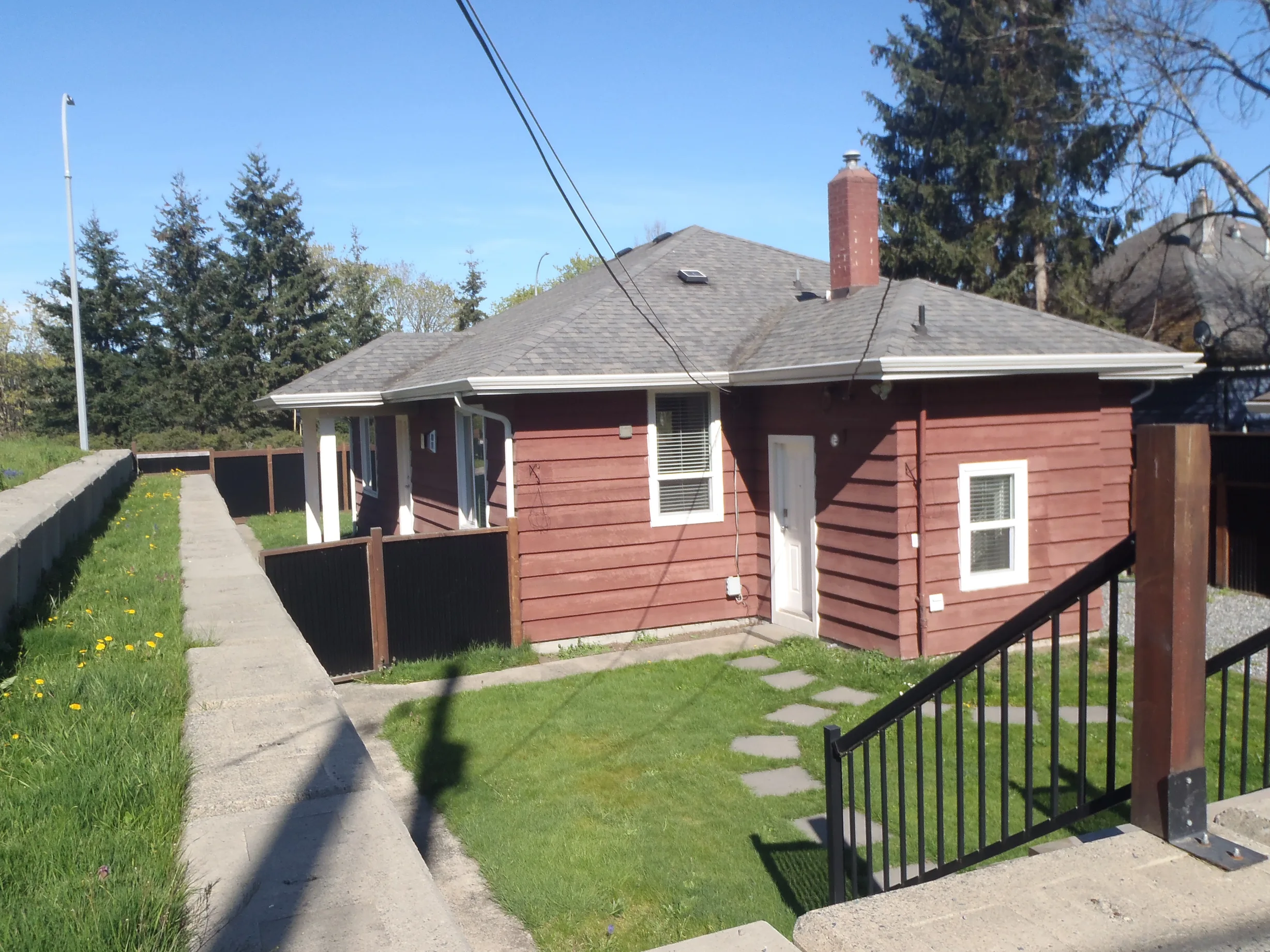 Before: a leaking asphalt shingle roof on the home, Ladysmith, British Columbia, ahead of a Copper Penny Interlock Slate aluminum roof