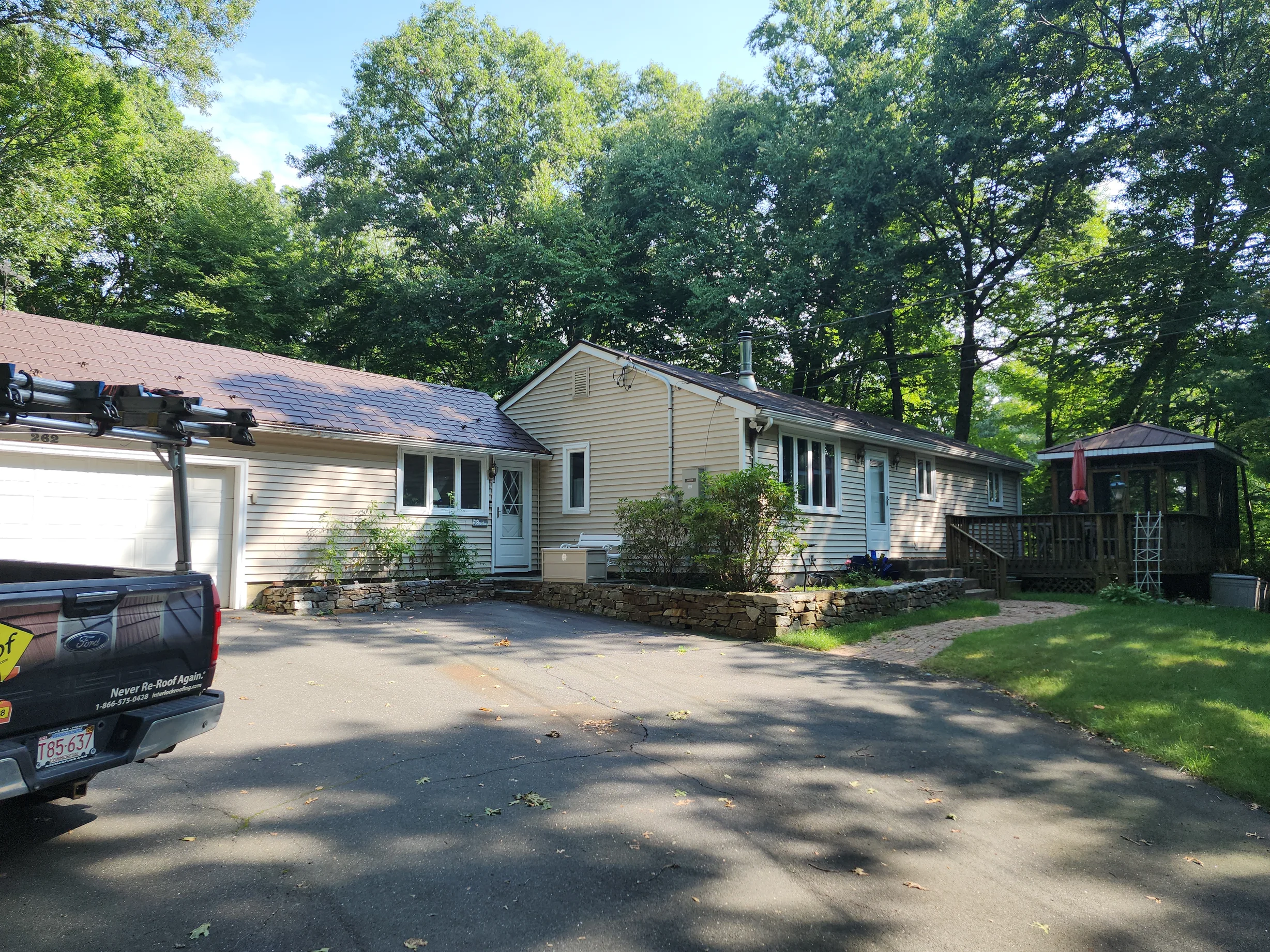 Colonial Brown Interlock Shingle aluminum roof on a colonial style single-family home with a metal roof among, Burlington, Connecticut