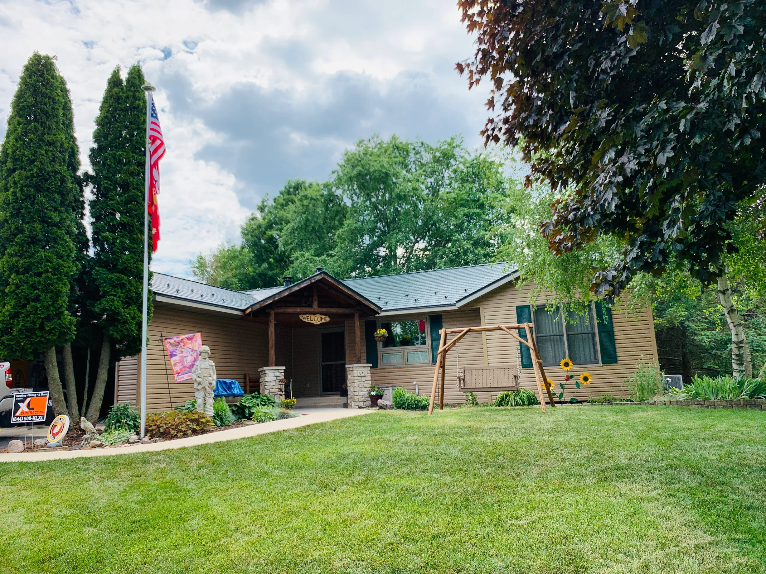 Hunter Green Interlock Shingle aluminum roof on a tan ranch-style home with a hunter green metal roof in a, Winnebago, Illinois