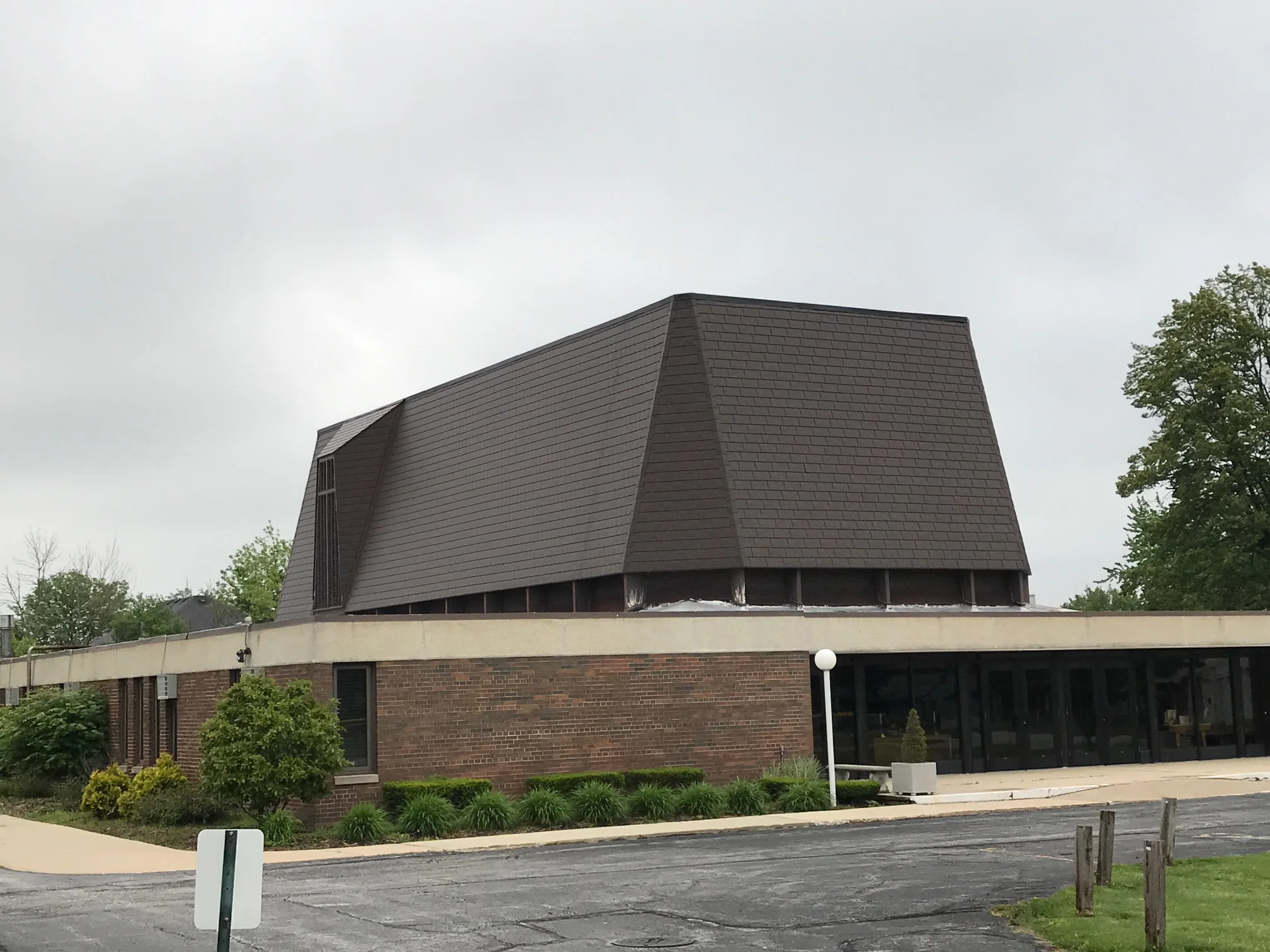 White Interlock IB Membrane aluminum roof being installed on a brick house with a metal roof in a suburban neighbourhood, Chicago Heights, Illinois