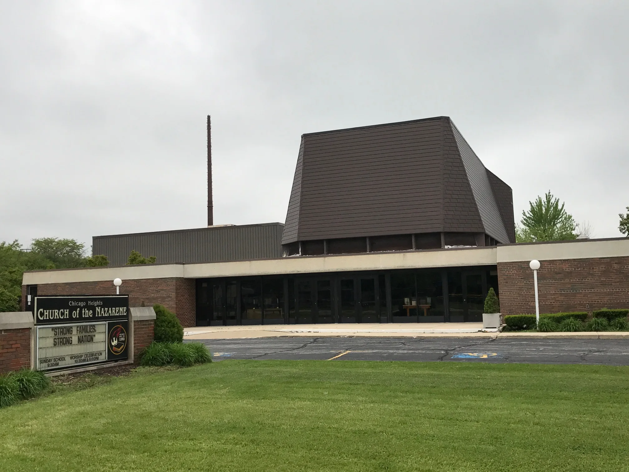 White Interlock IB Membrane aluminum roof on a brown brick church with a metal roof in a suburban, Chicago Heights, Illinois