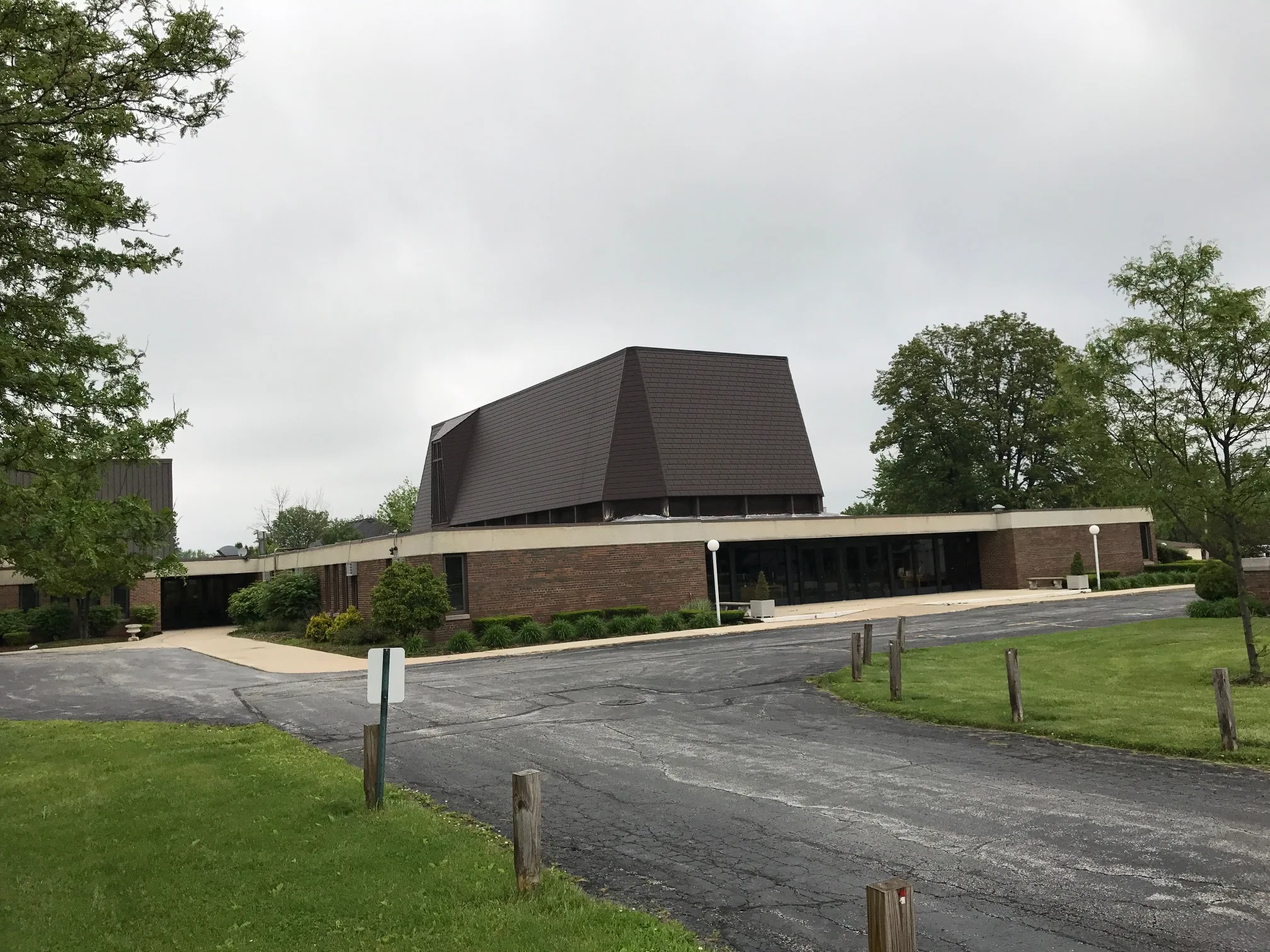 White Interlock IB Membrane aluminum roof on a brown single-storey home with a gable roof in an urban, Chicago Heights, Illinois