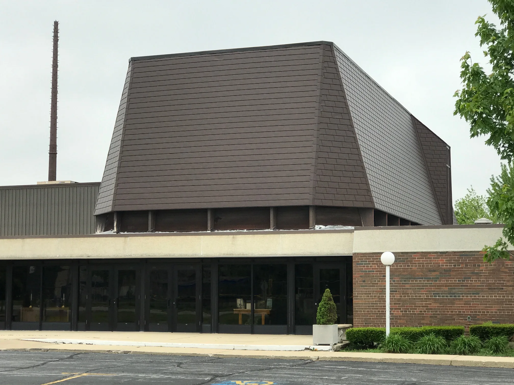 White Interlock IB Membrane aluminum roof on a brown home with a metal roof among urban buildings, Chicago Heights, Illinois