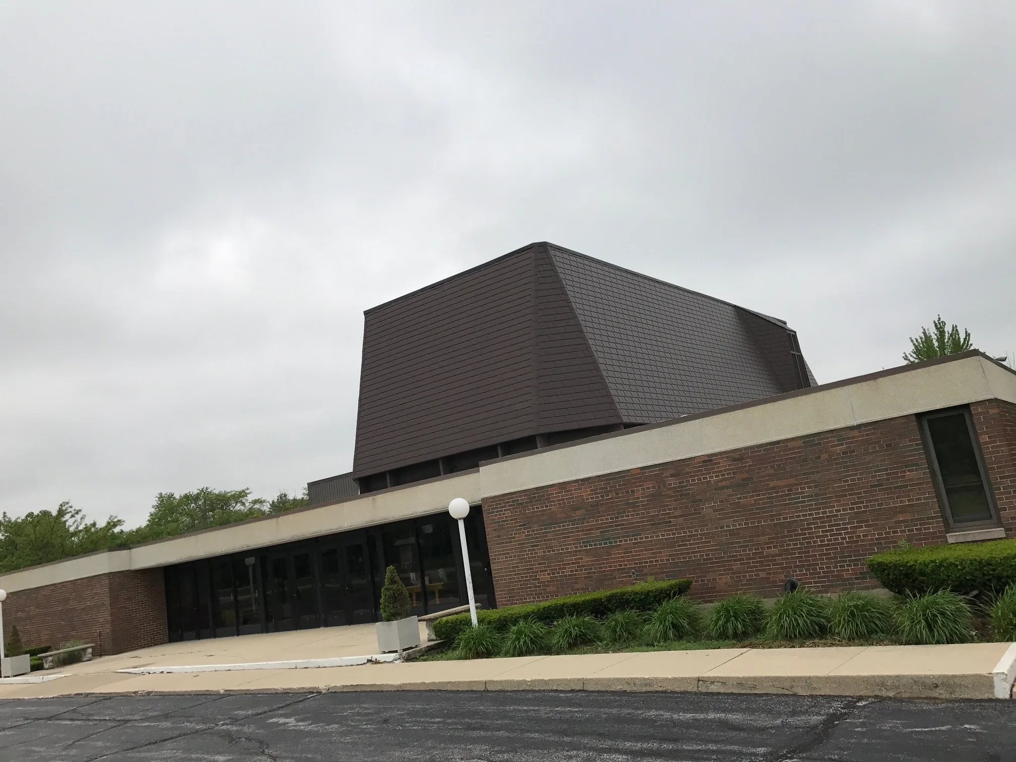 White Interlock IB Membrane aluminum roof on a brick commercial building with a metal roof in a city, Chicago Heights, Illinois