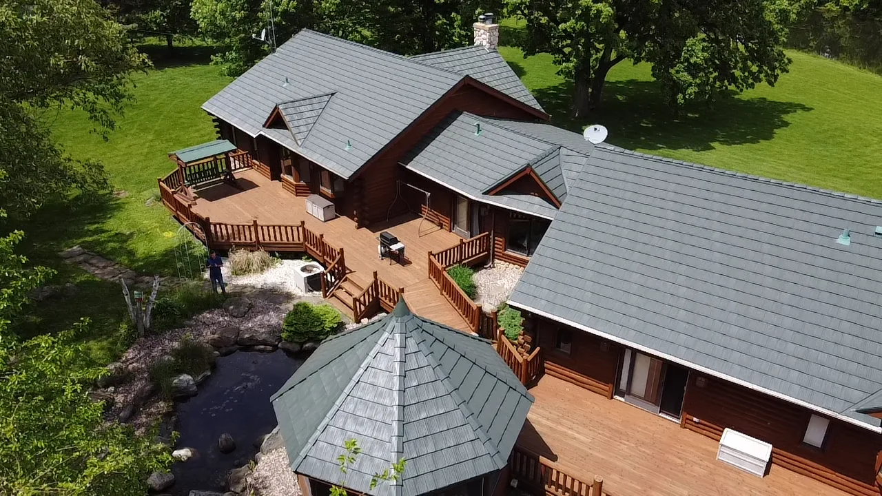 Hunter Green Interlock Shake aluminum roof on a green ranch house with a hunter green metal roof in rural, Harvard, Illinois