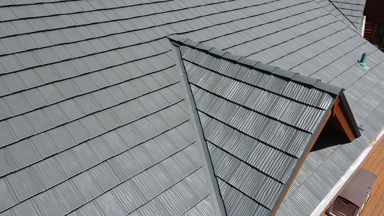 Hunter Green Interlock Shake aluminum roof on a brown two-storey home with dormers on a rural acreage, Harvard, Illinois