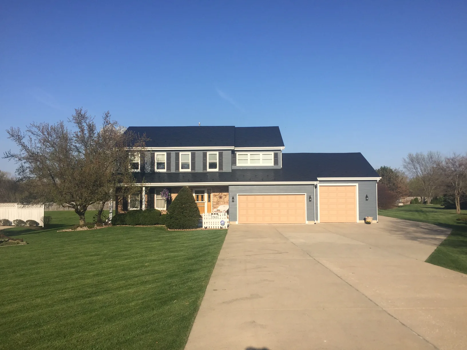 Black Interlock Slate aluminum roof on a two-storey home with dormers on a rural property, Wadsworth, Illinois