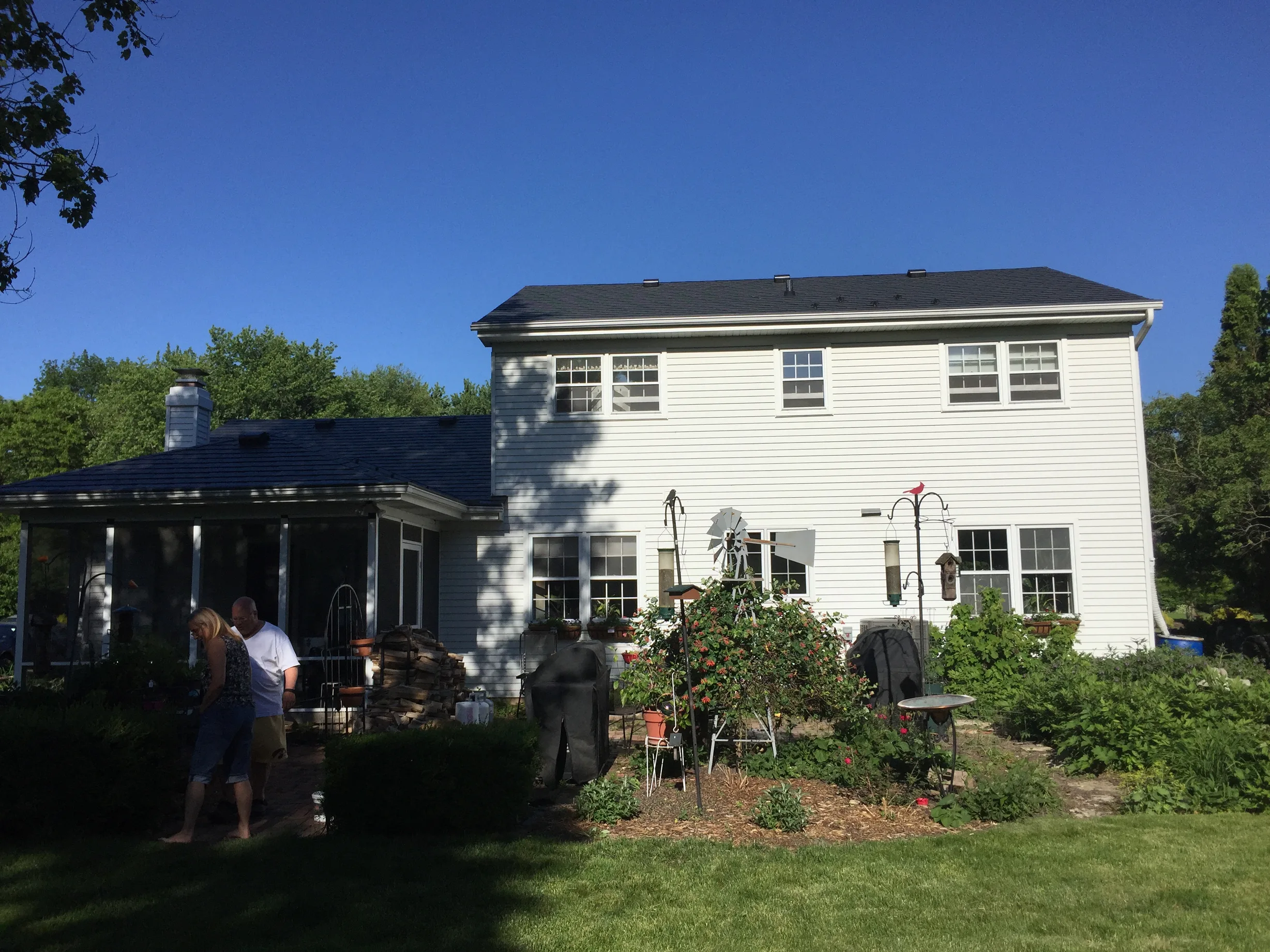 Black Interlock Slate aluminum roof on a white two-storey home with dormers in a residential area, Batavia, Illinois