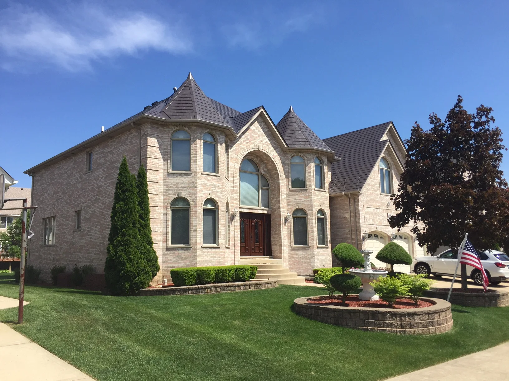 Tudor Brown Interlock Slate aluminum roof on a Tudor-style home with a brown metal roof in a suburban, Roselle, Illinois