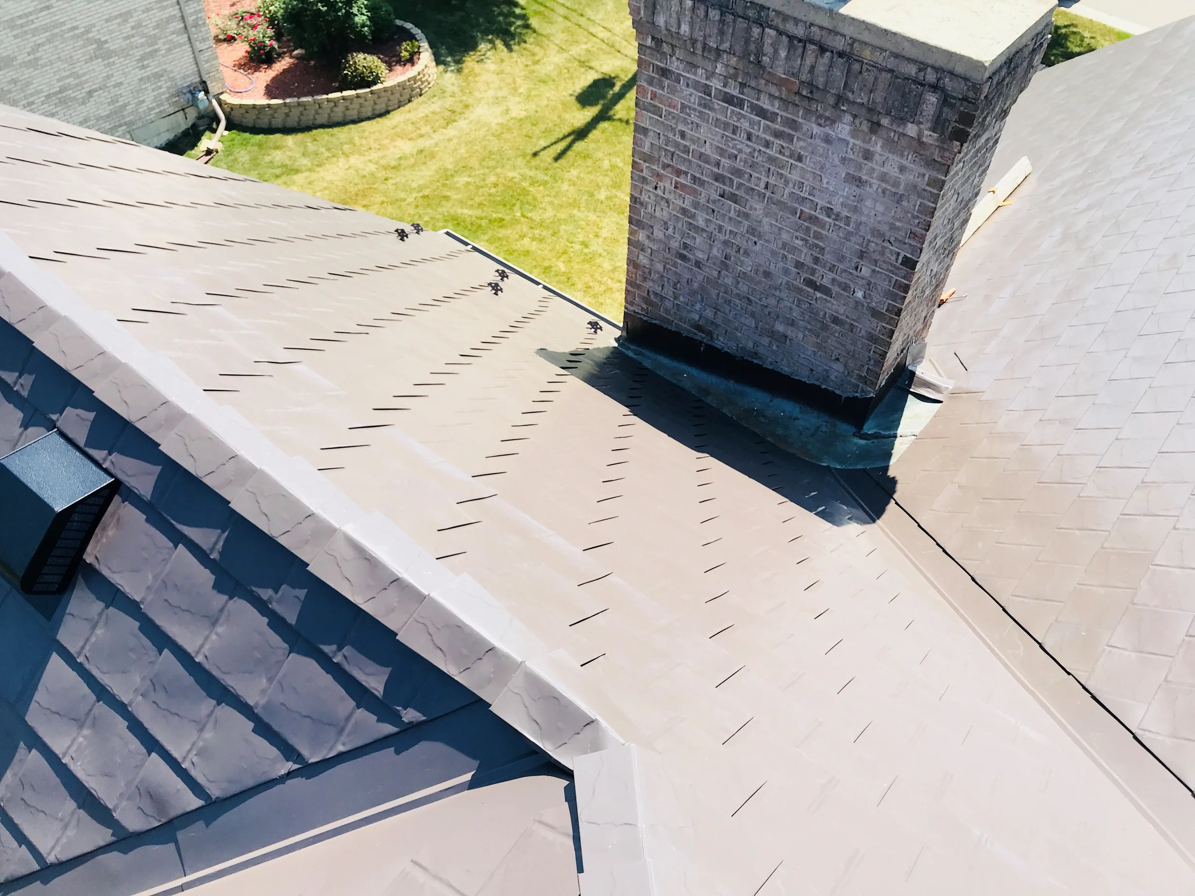 Tudor Brown Interlock Slate aluminum roof on a Tudor brown metal roof on a colonial style house in a, Roselle, Illinois