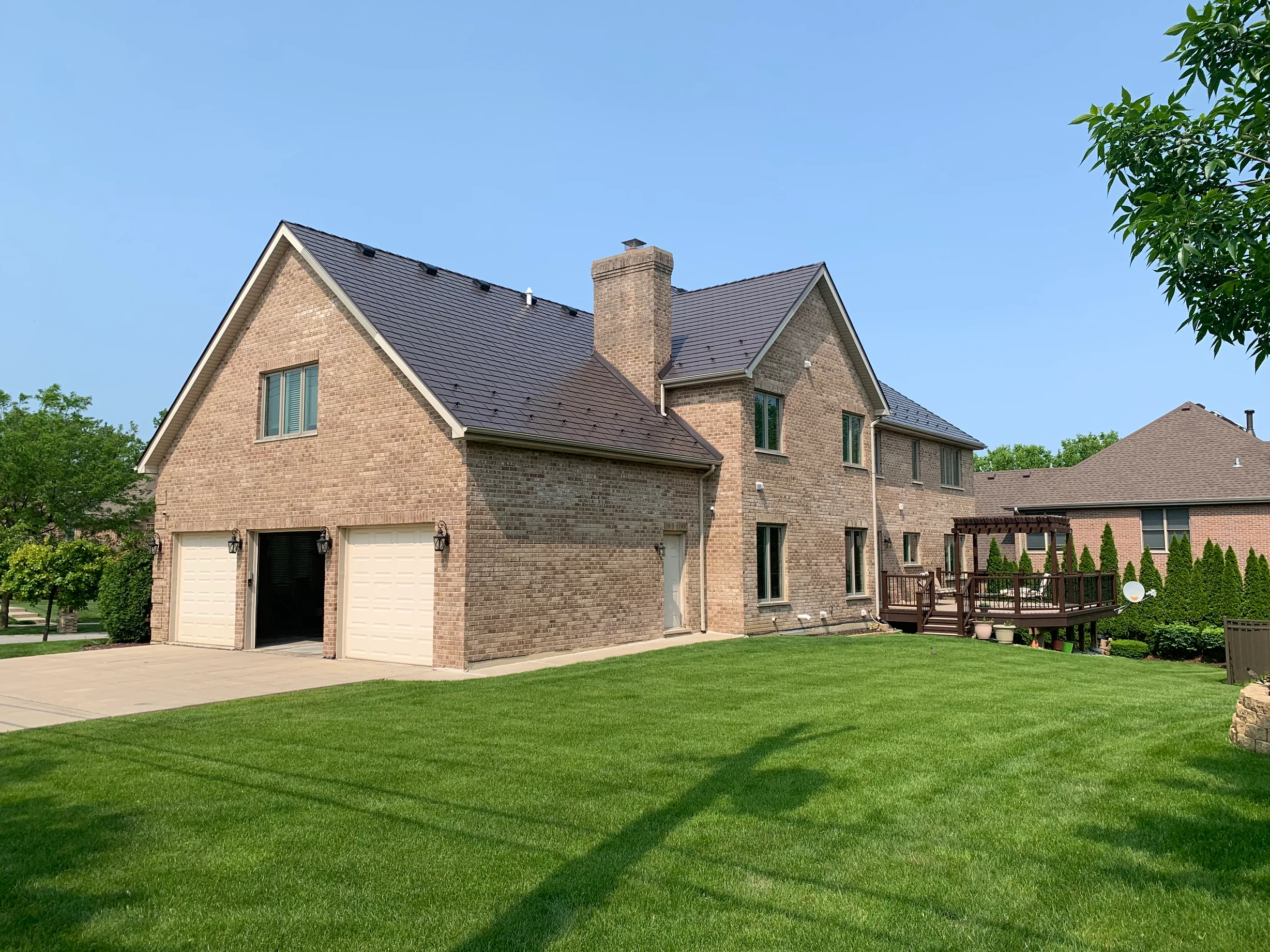 Tudor Brown Interlock Slate aluminum roof on a Tudor-style home with a brown roof in an urban suburb, Roselle, Illinois