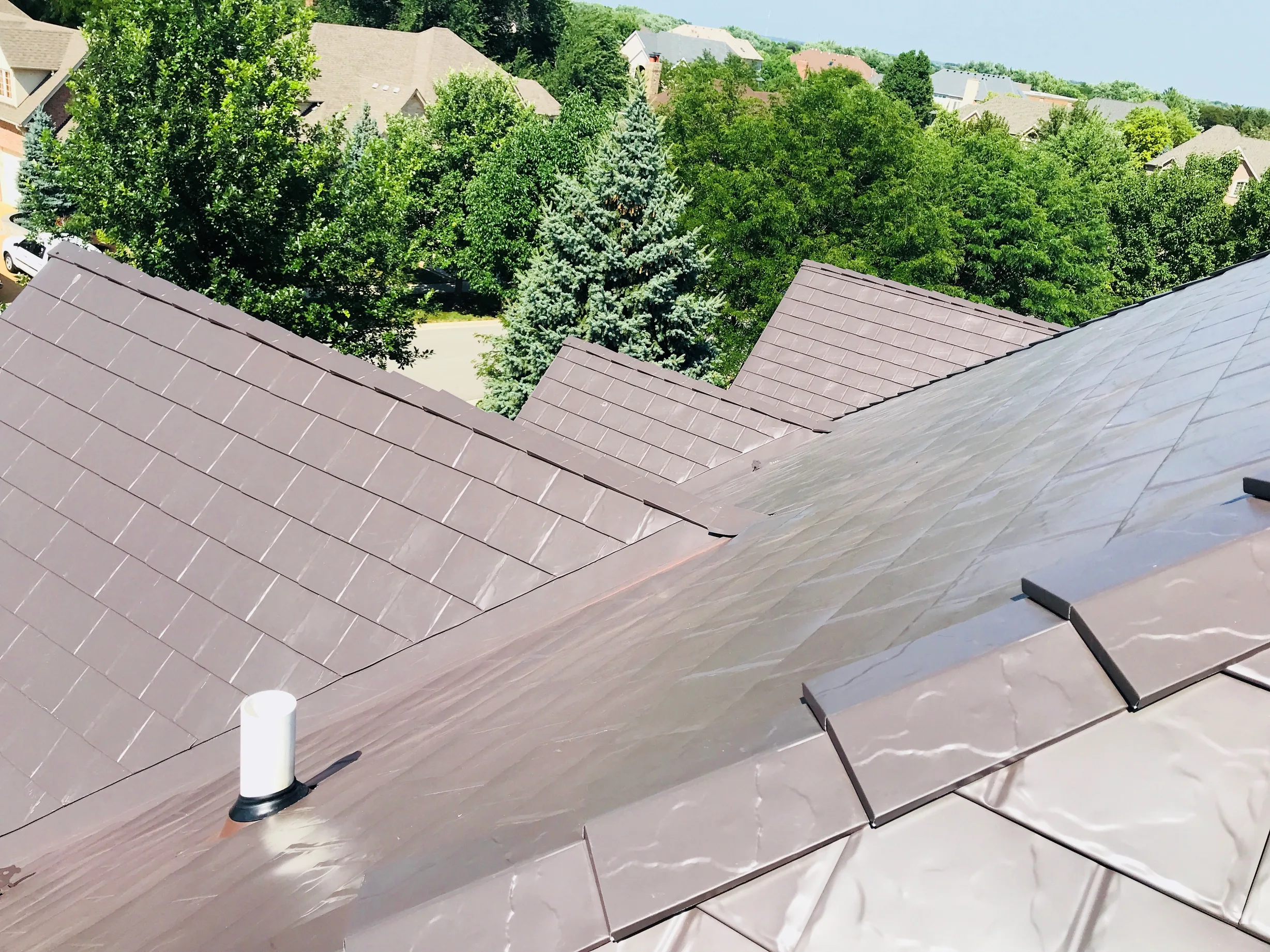 Tudor Brown Interlock Slate aluminum roof on a two-storey Tudor home with dormers in a suburban, Roselle, Illinois