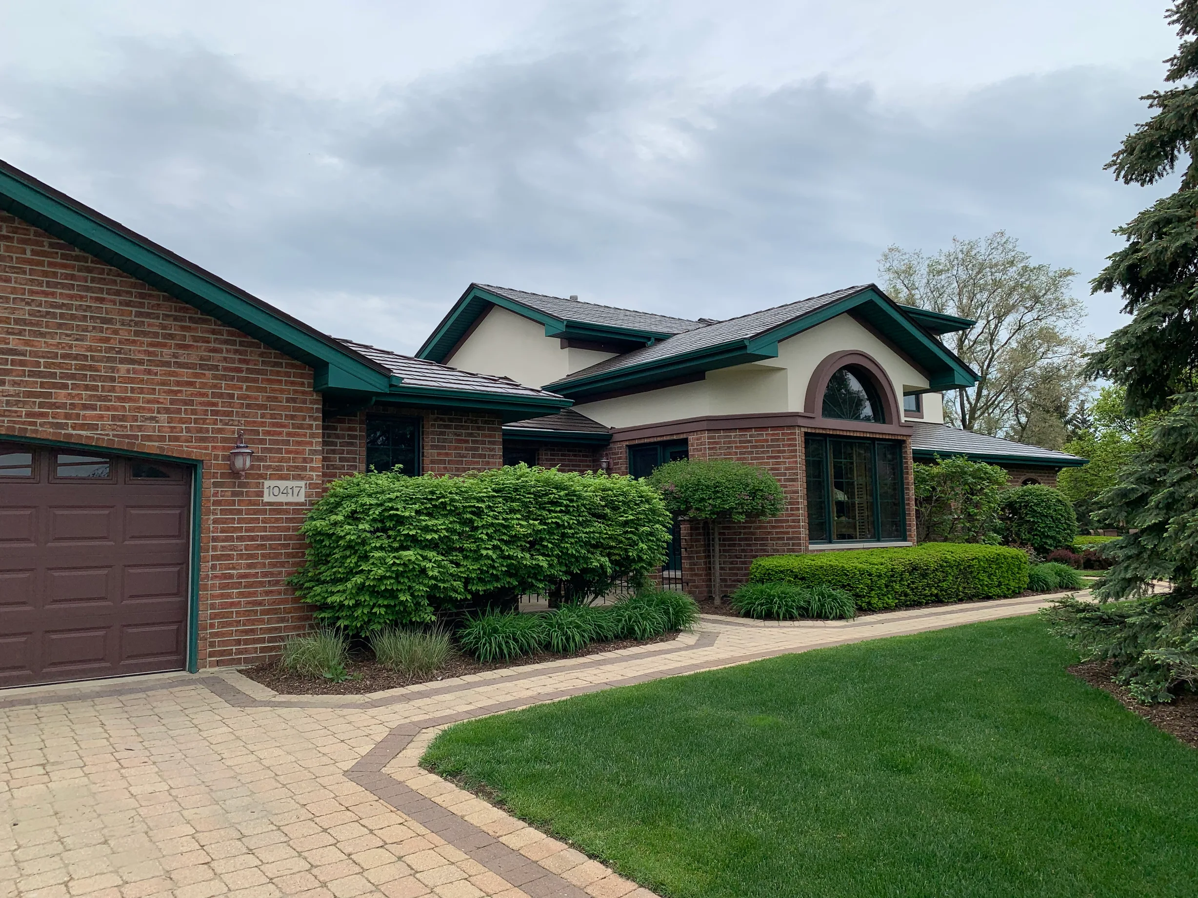 Colonial Brown Interlock Cedar Shingle aluminum roof on a colonial home with brown siding in a suburban setting, Orland Park, Illinois