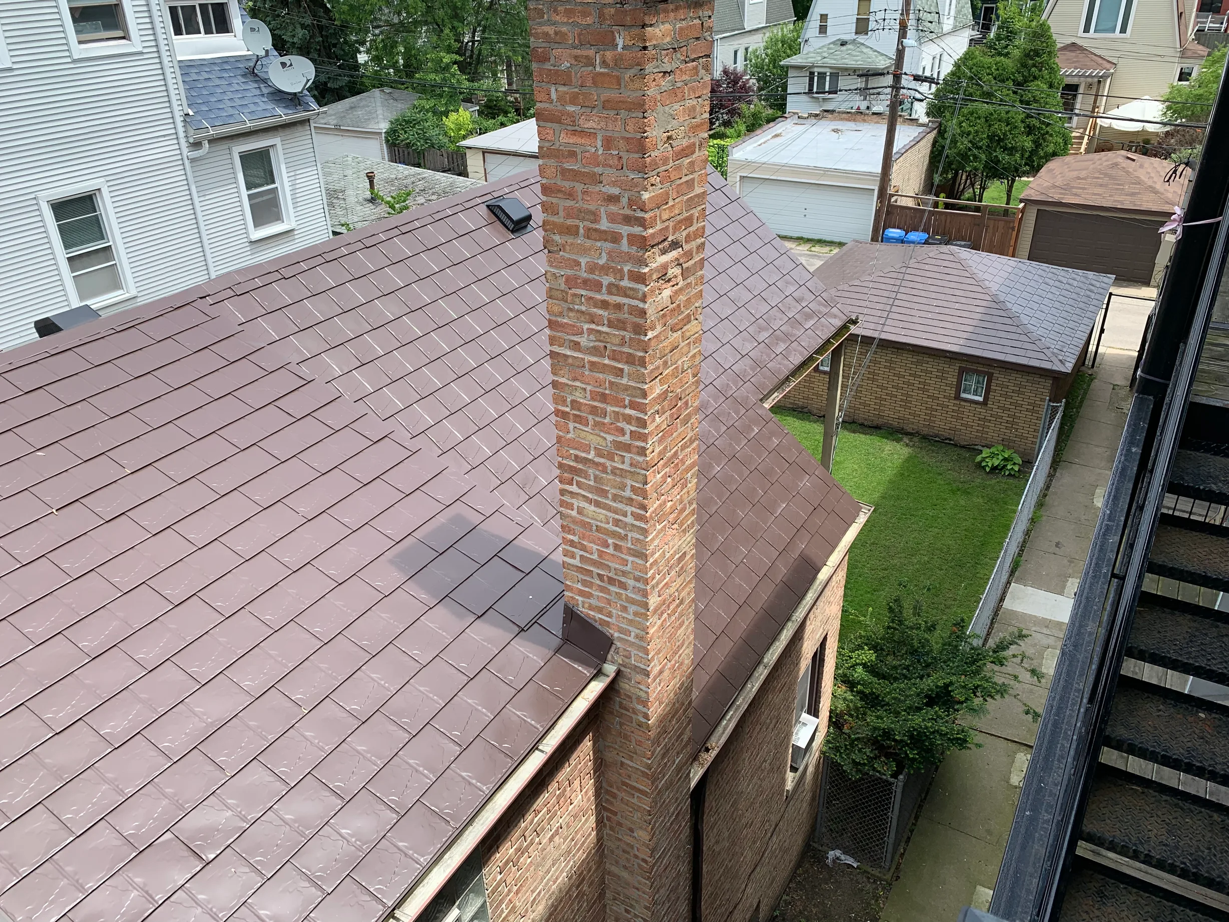 Colonial Brown Interlock Slate aluminum roof on a Colonial style house with a brown roof in an urban, Chicago, Illinois
