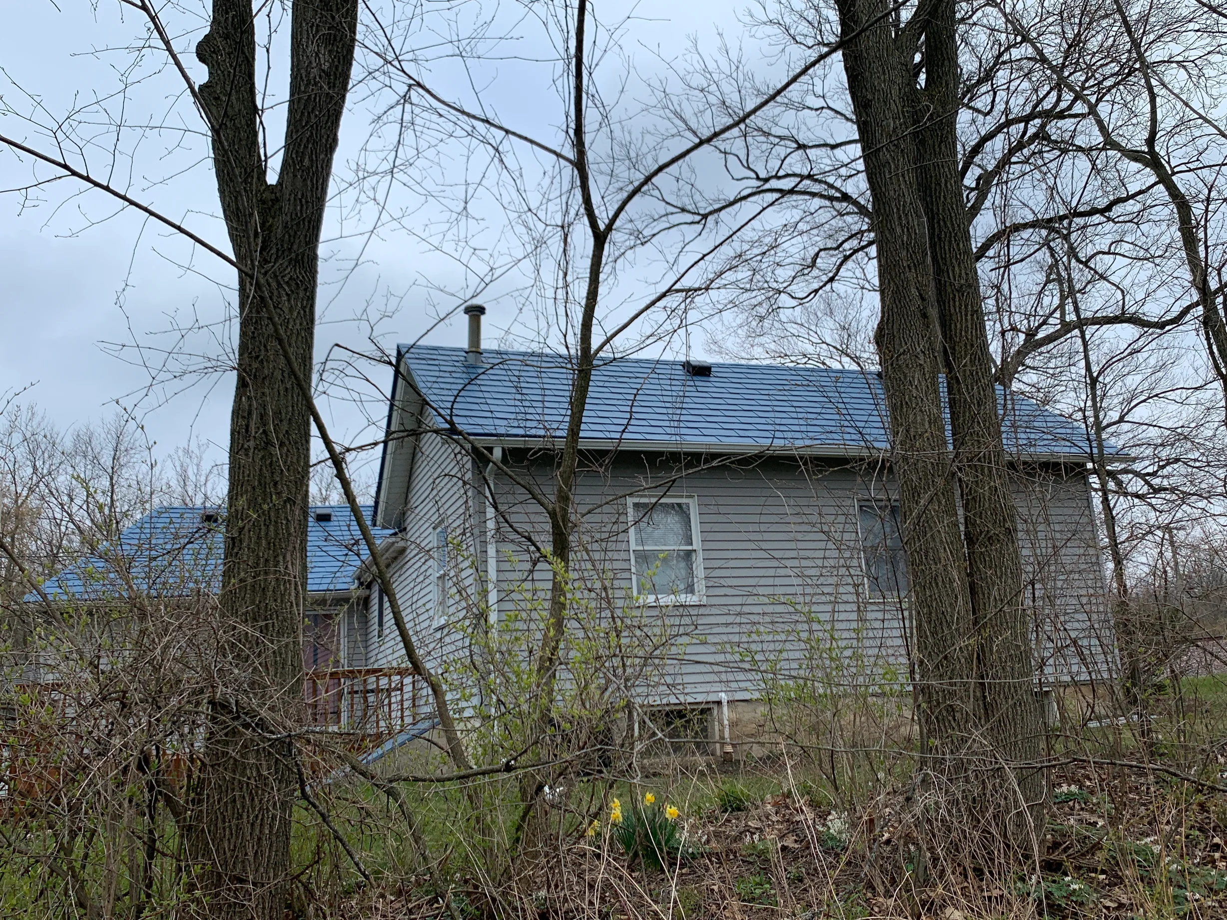 Royal Blue Interlock Slate aluminum roof on a metal roof under construction on a ranch home in a rural, Woodstock, Illinois