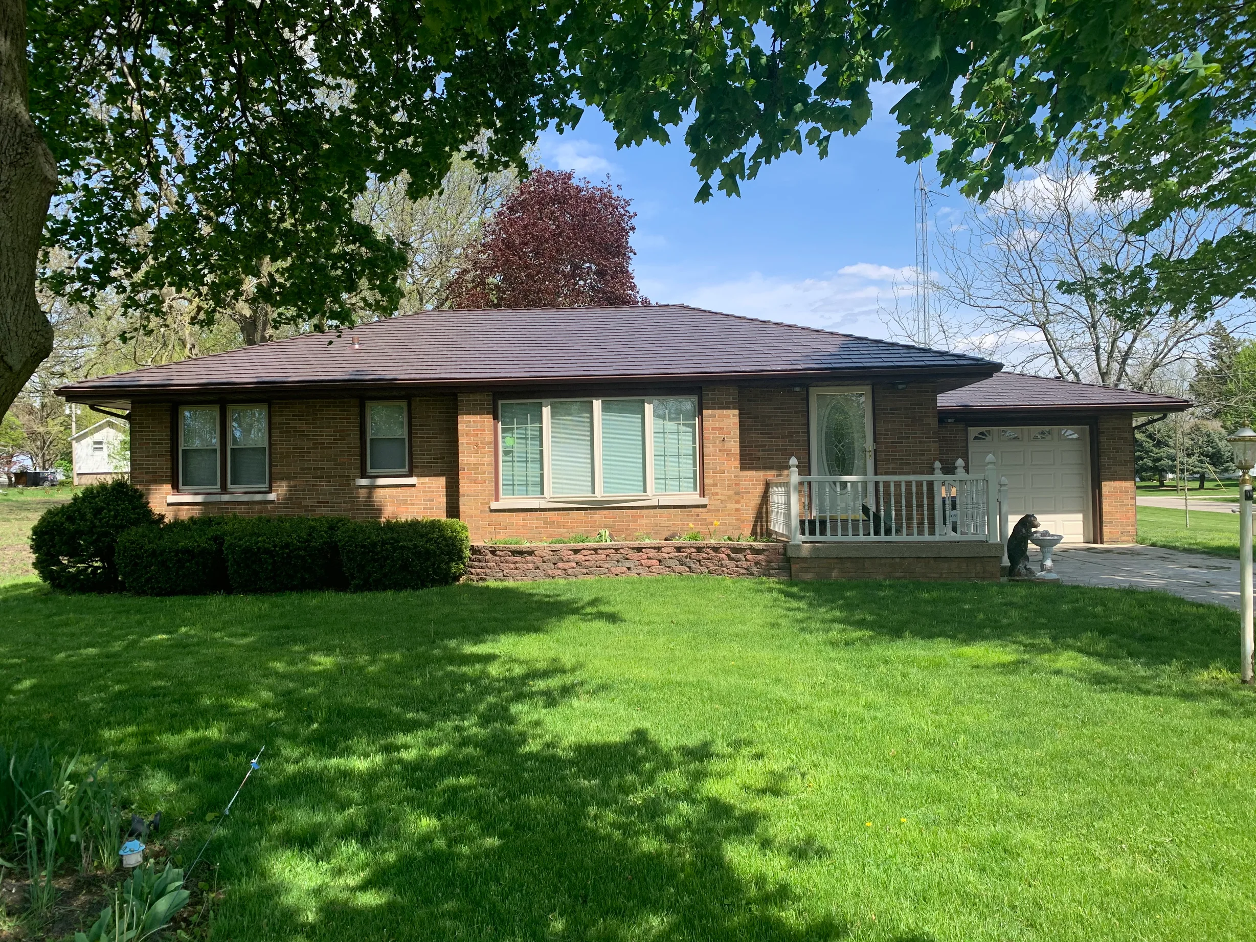 Colonial Brown Interlock Cedar Shingle aluminum roof on a brown Colonial home in a lush green landscape, Wenona, Illinois