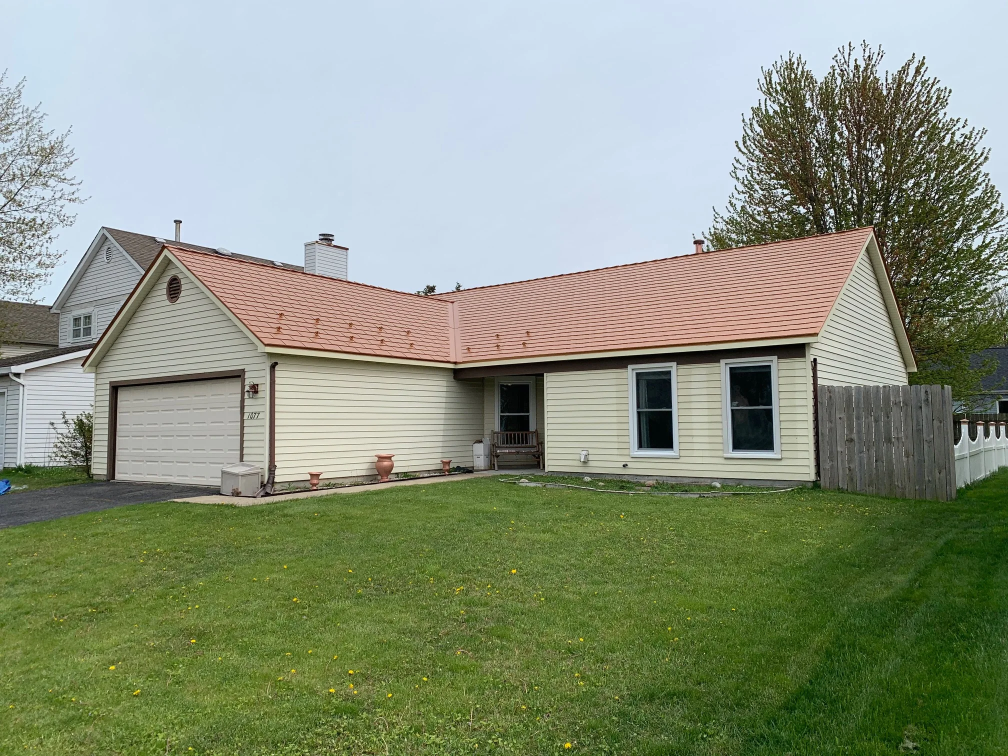 Copper Penny Interlock Cedar Shingle aluminum roof on a cream coloured single-storey ranch home with a copper, Bolingbrook, Illinois