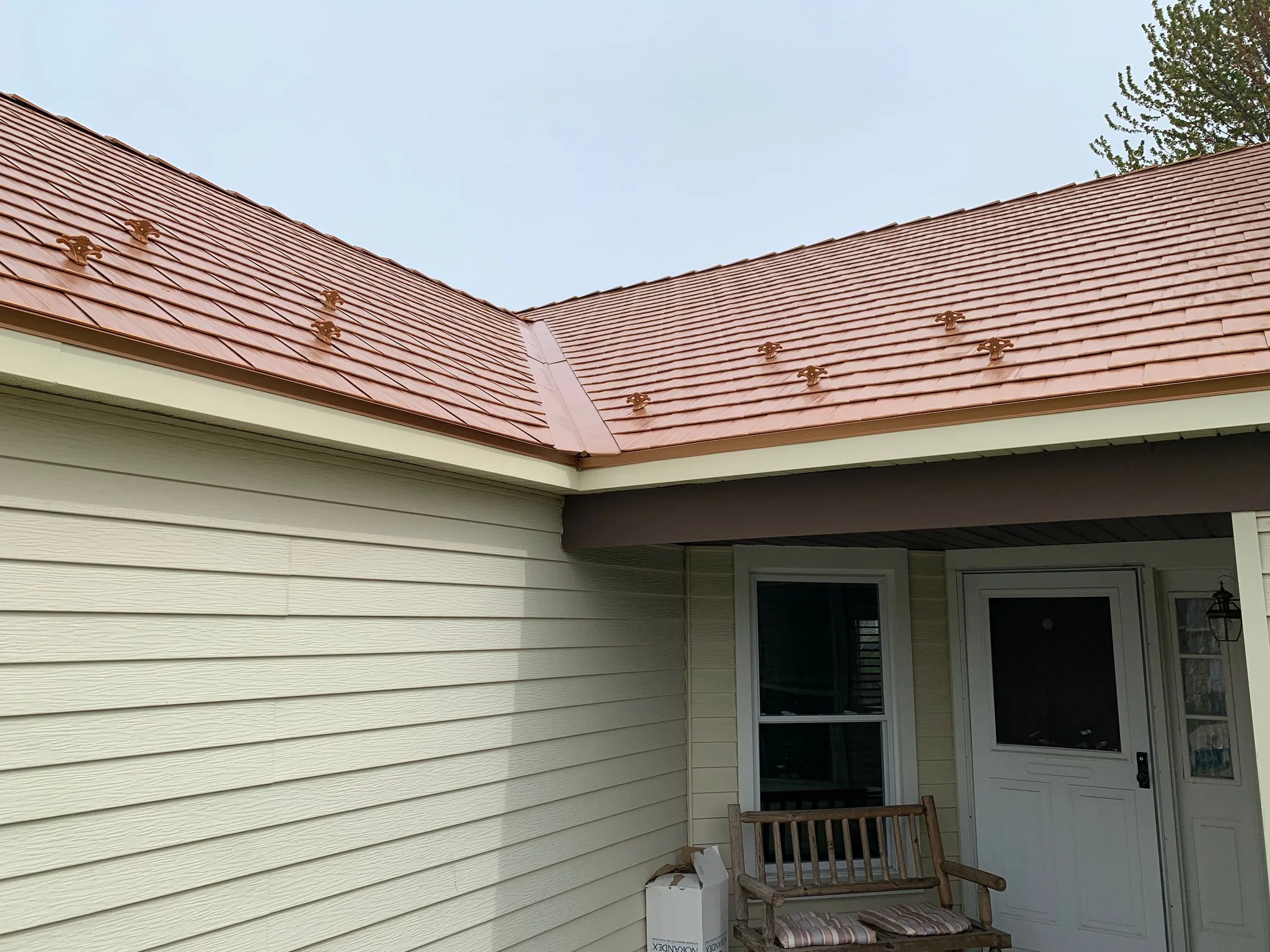 Copper Penny Interlock Cedar Shingle aluminum roof on a white single-family home with a metal roof in a suburban, Bolingbrook, Illinois