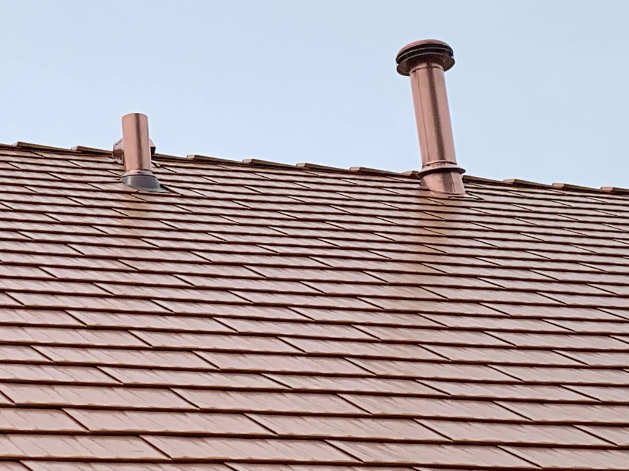 Copper Penny Interlock Cedar Shingle aluminum roof on a brown single-family home with a copper penny roof in a, Bolingbrook, Illinois