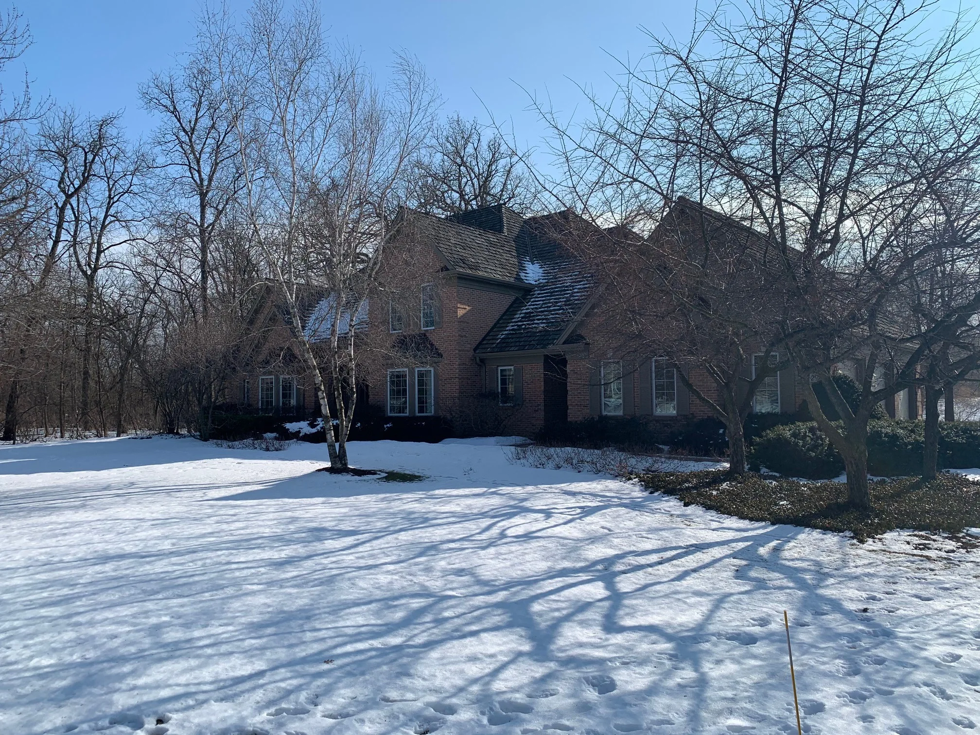 Before: a worn out wood shake roof on the home, Crystal Lake, Illinois, ahead of a Deep Charcoal Interlock Slate aluminum roof