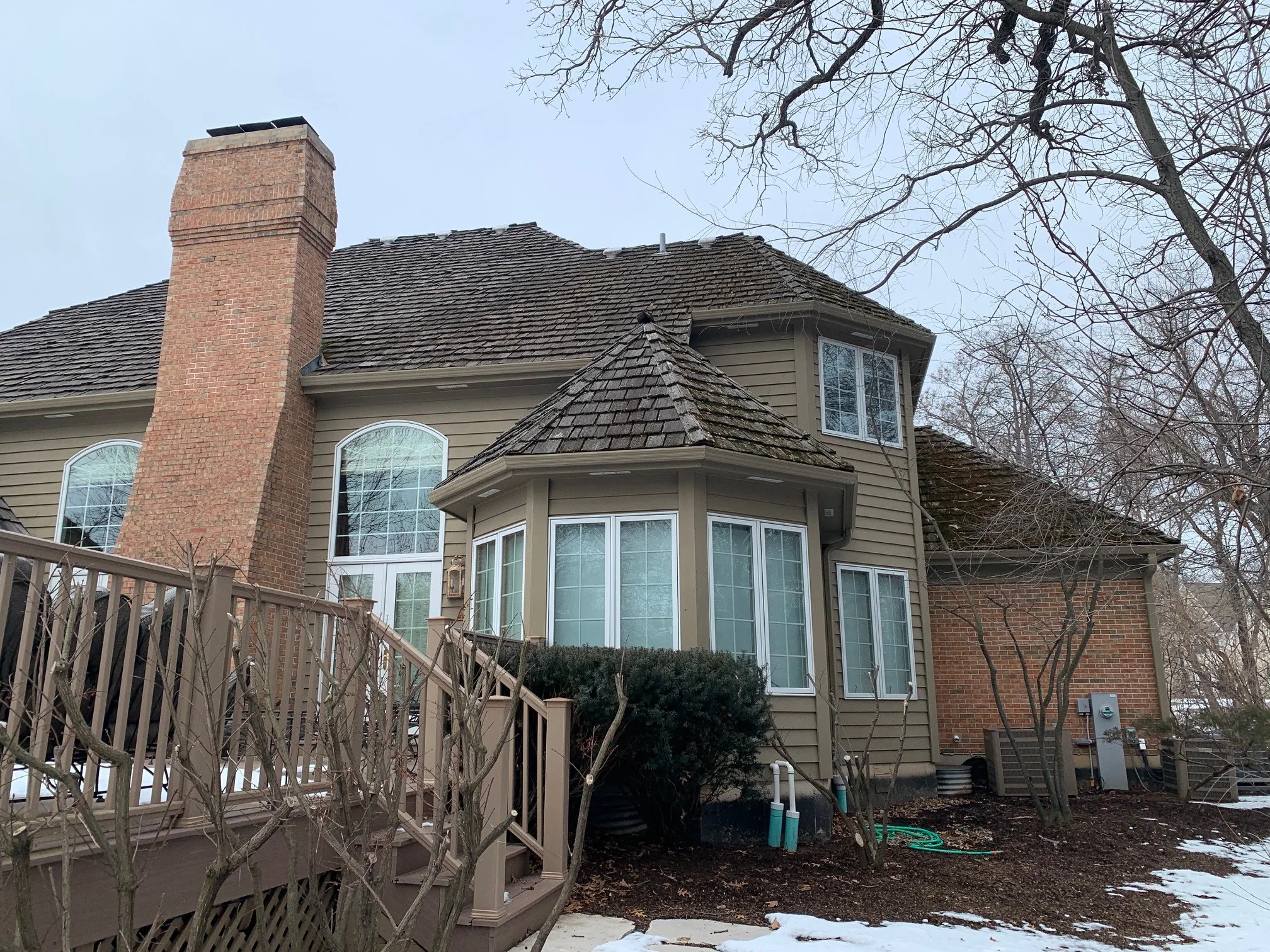 Before: a worn out wood shake roof on the home, Crystal Lake, Illinois, ahead of a Deep Charcoal Interlock Slate aluminum roof