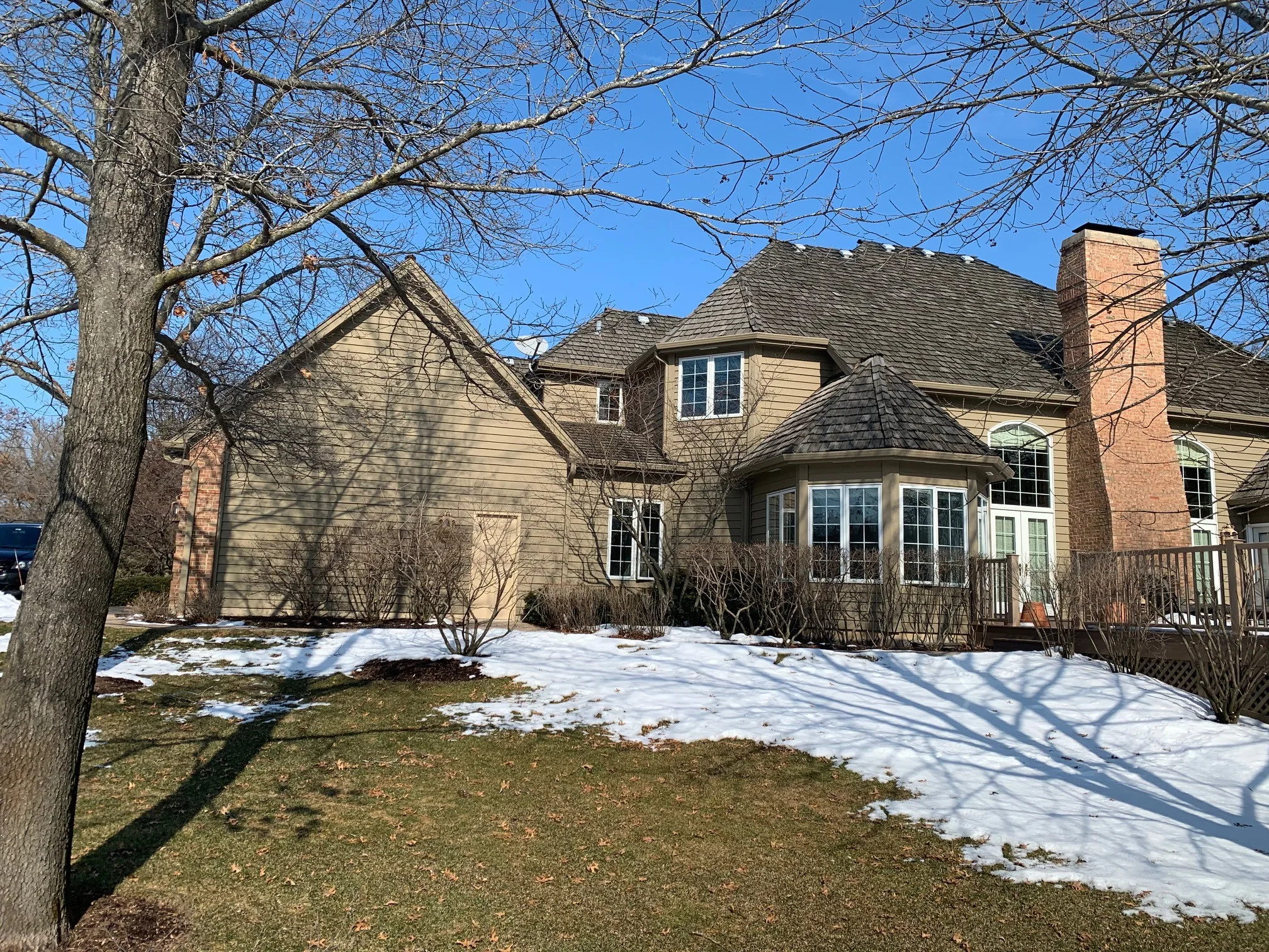 Before: a worn out wood shake roof on the home, Crystal Lake, Illinois, ahead of a Deep Charcoal Interlock Slate aluminum roof