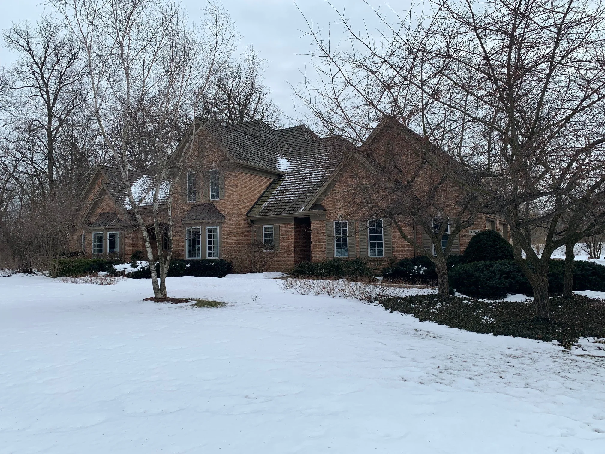 Before: a worn out wood shake roof on the home, Crystal Lake, Illinois, ahead of a Deep Charcoal Interlock Slate aluminum roof