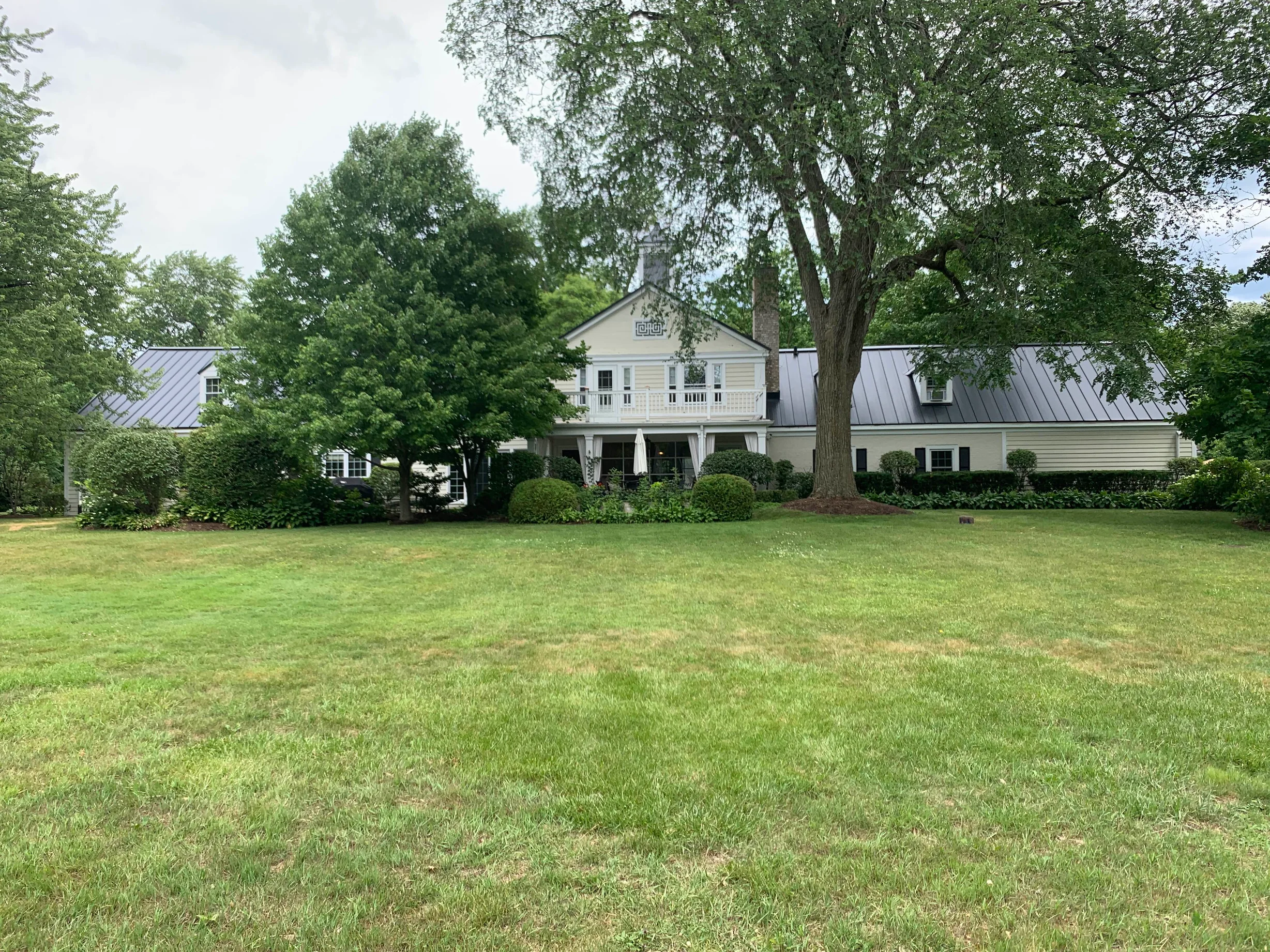Black Interlock Standing Seam aluminum roof on a colonial home with a metal roof on a forested rural, Lake Forest, Illinois