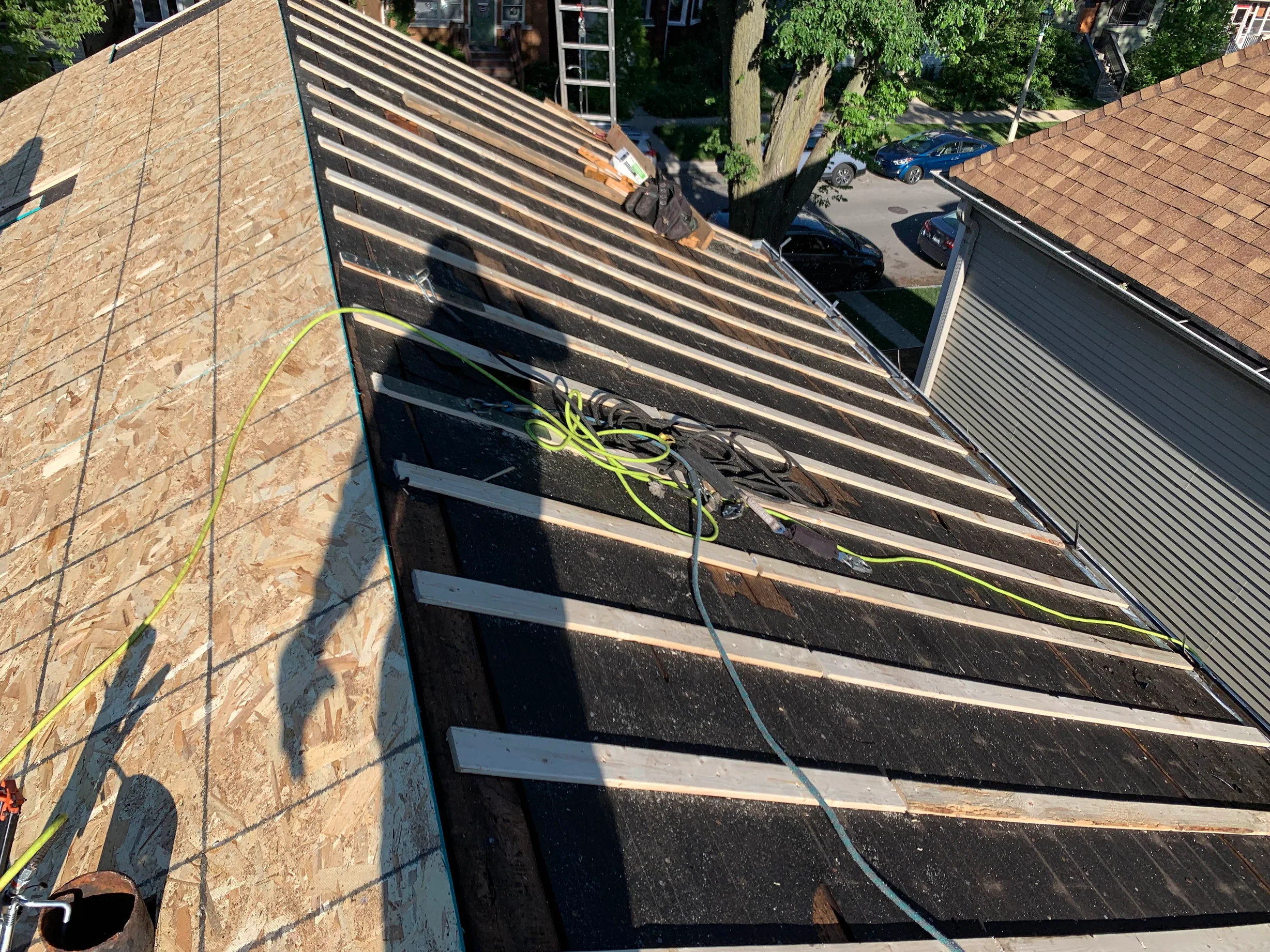 Black Interlock Slate aluminum roof being installed on the home, replacing a worn out asphalt shingle roof, Oak Park, Illinois
