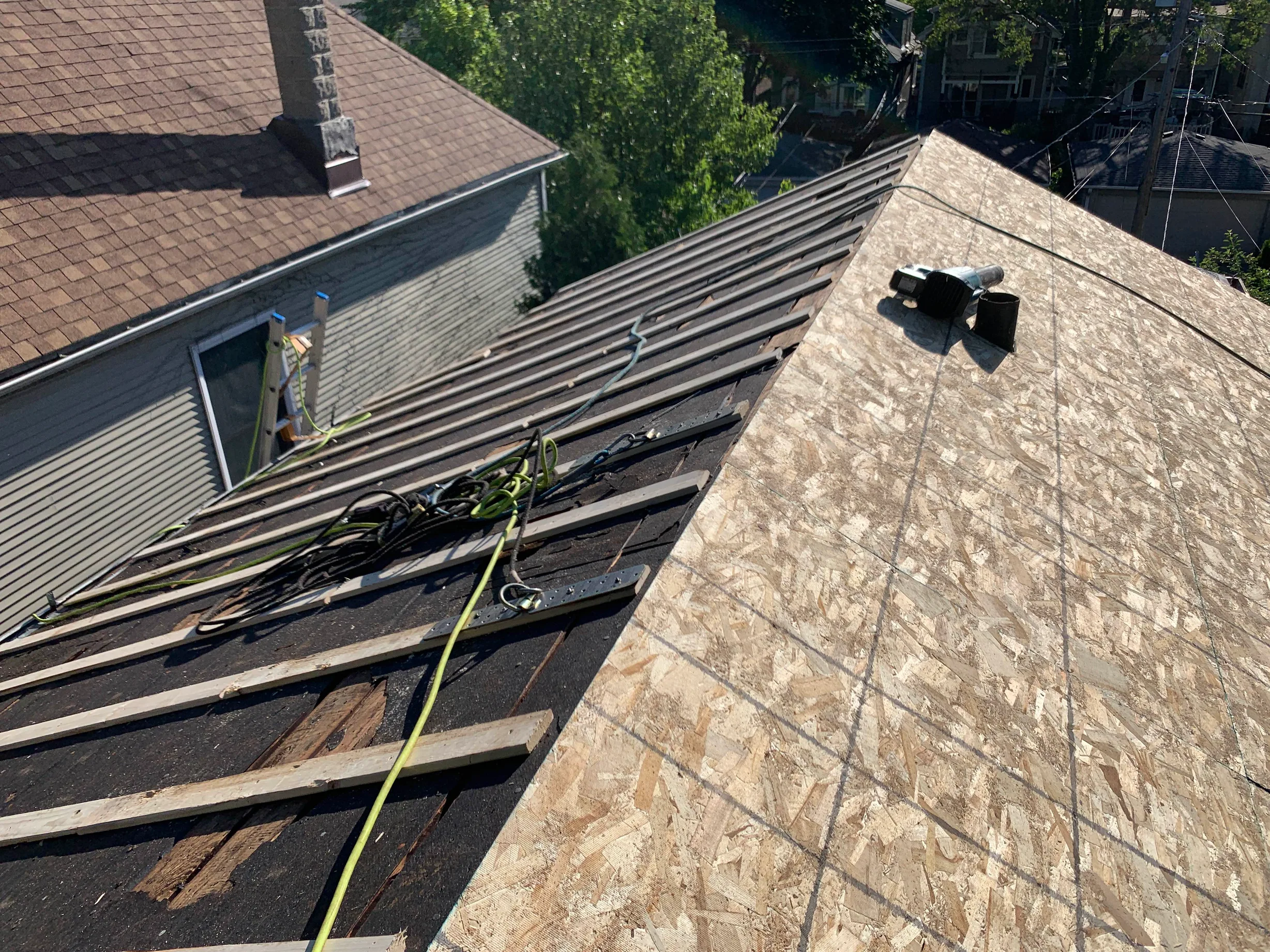 Black Interlock Slate aluminum roof being installed on the home, replacing a worn out asphalt shingle roof, Oak Park, Illinois