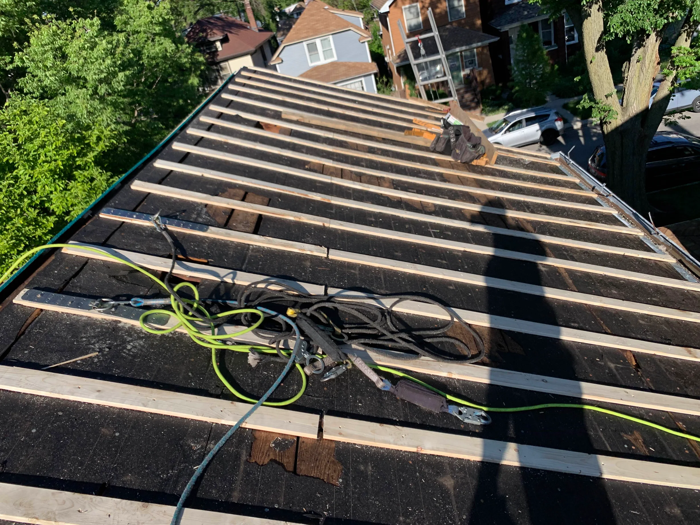 Black Interlock Slate aluminum roof being installed on the home, replacing a worn out asphalt shingle roof, Oak Park, Illinois