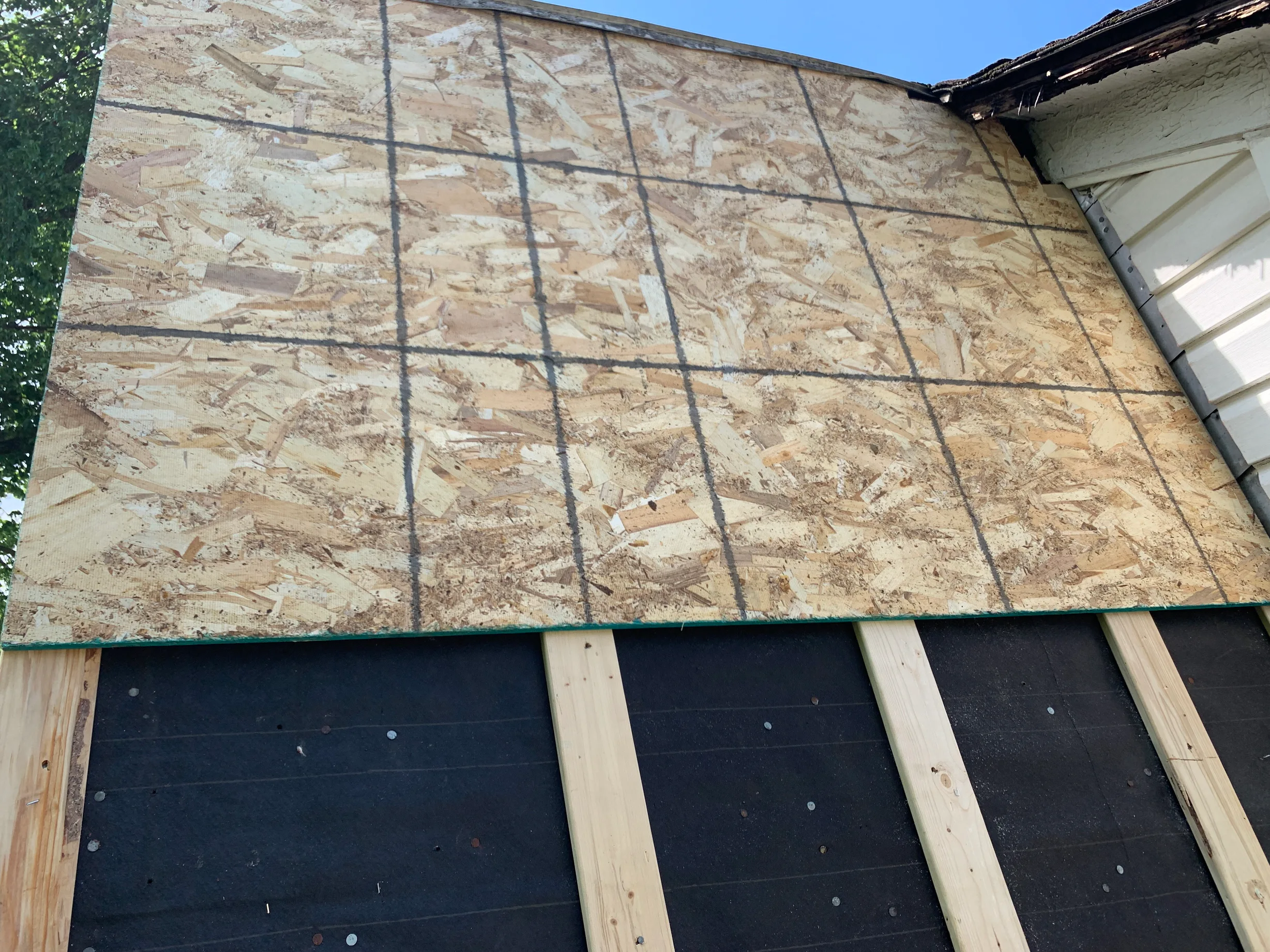Black Interlock Slate aluminum roof being installed on the home, replacing a worn out asphalt shingle roof, Oak Park, Illinois