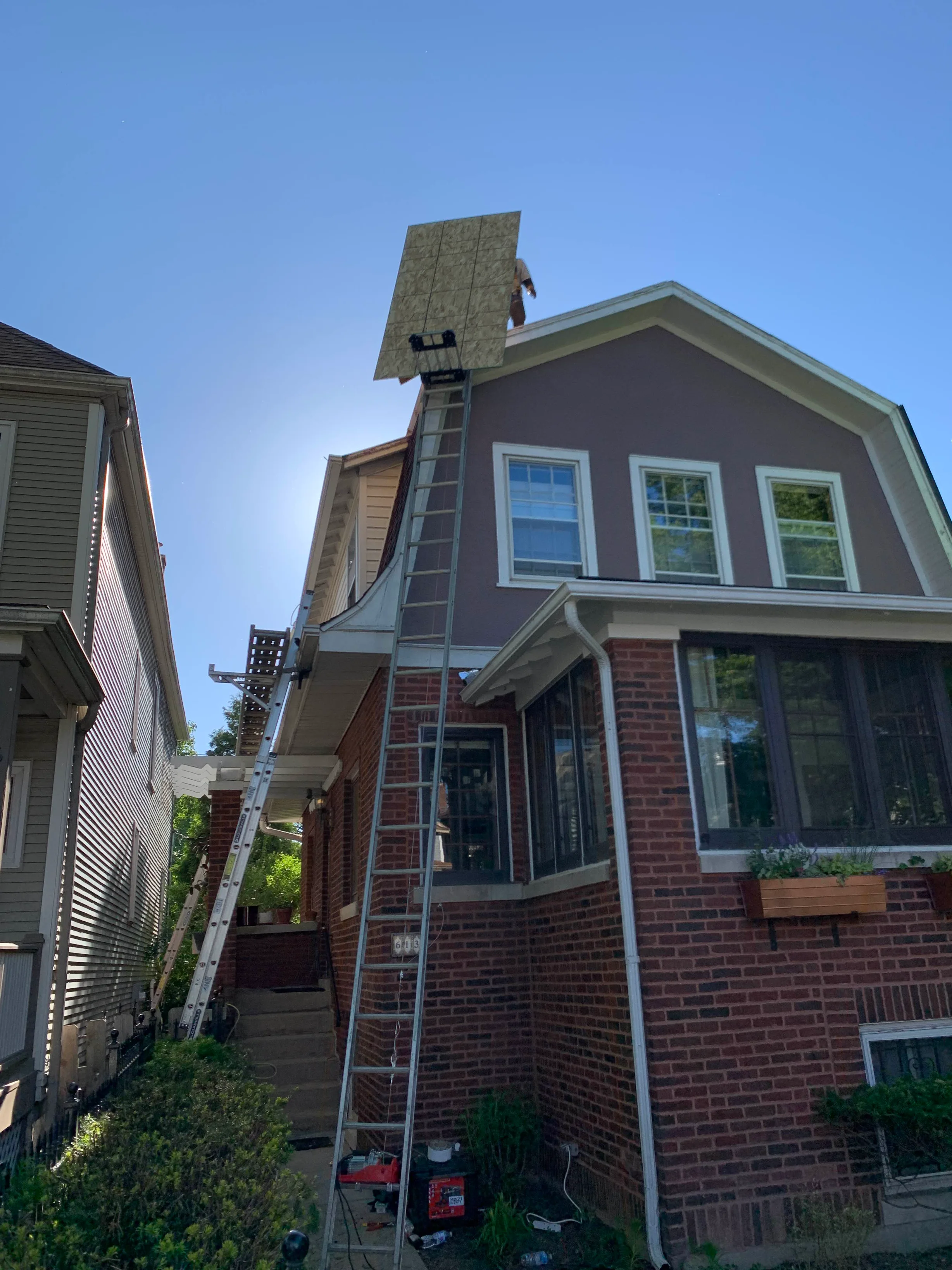 Black Interlock Slate aluminum roof being installed on the home, replacing a worn out asphalt shingle roof, Oak Park, Illinois