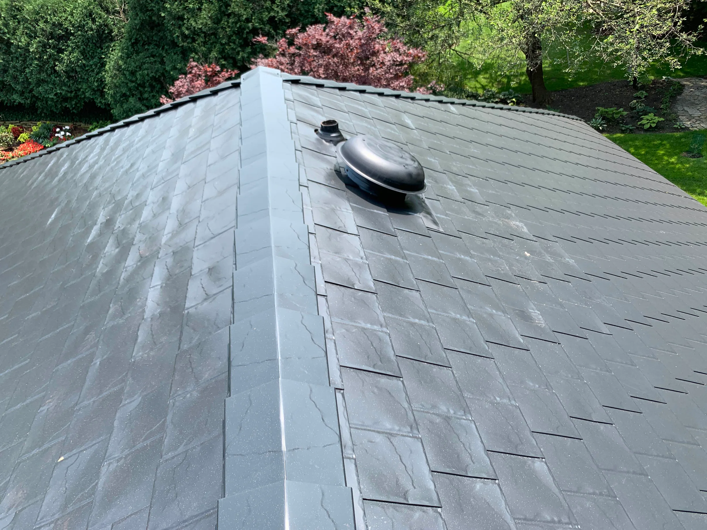 Black Interlock Slate aluminum roof on a two-storey home with black metal roof in a forested rural, Flossmoor, Illinois