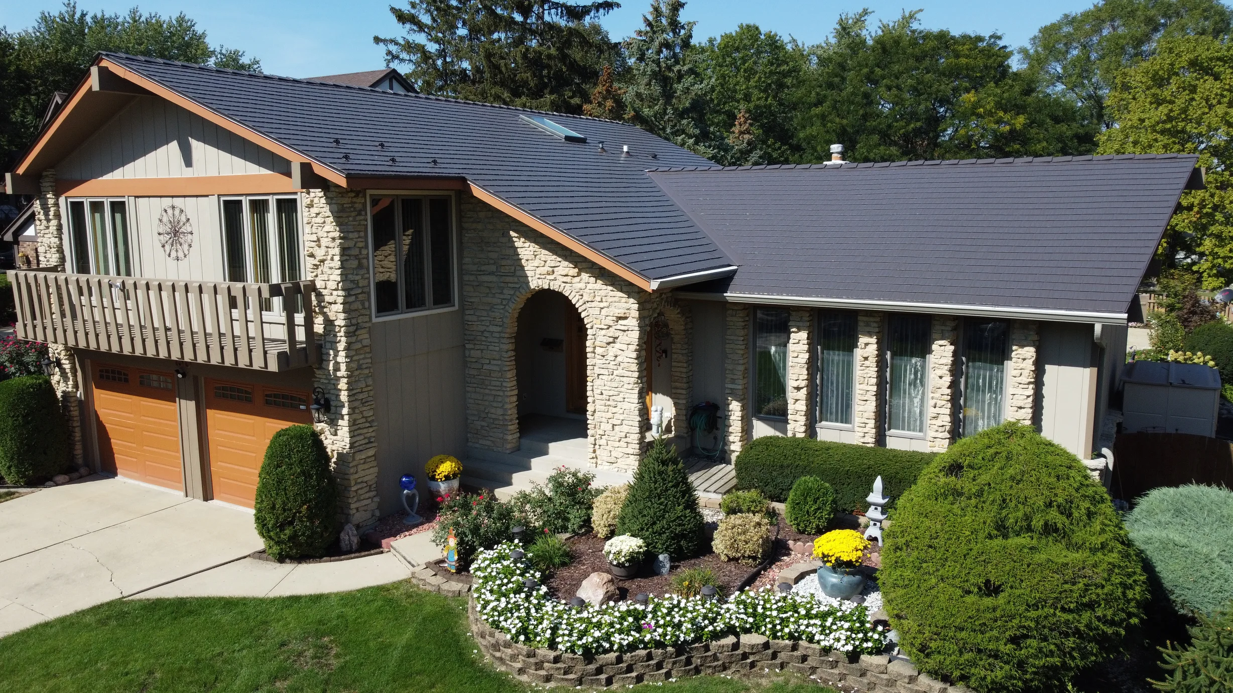 Tudor Brown Interlock Cedar Shingle aluminum roof on a Tudor Brown metal roof on a single-storey home with stone, Bartlett, Illinois
