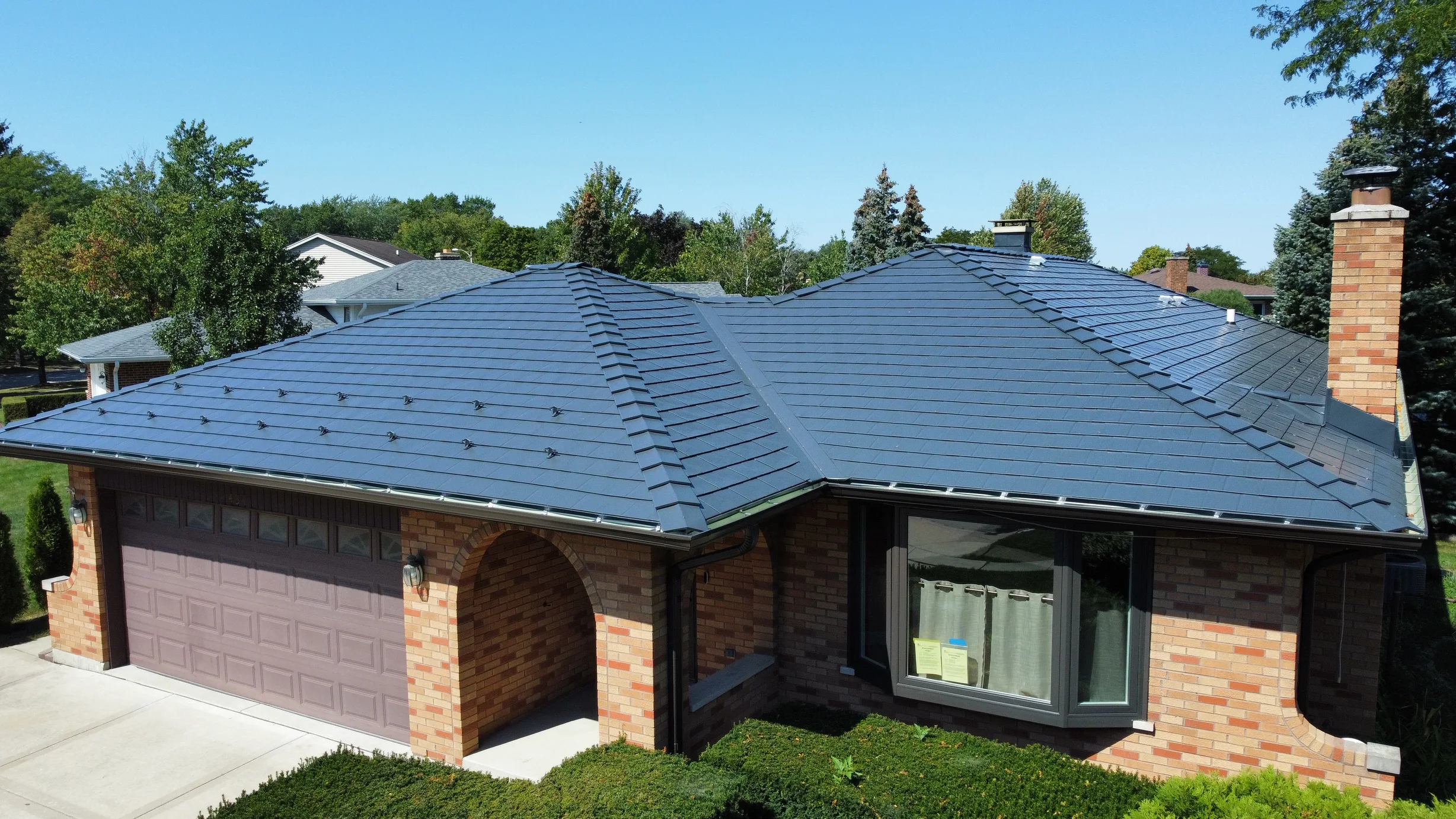 Deep Charcoal Interlock Slate aluminum roof on a brick ranch home with a slate blue roof in a suburban, Westmont, Illinois